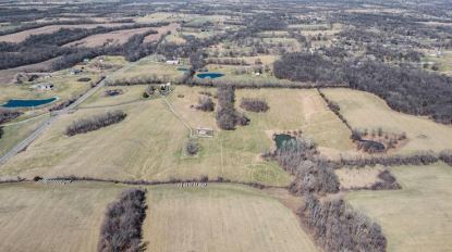 Aerial view of open pastures and pond on the Holt property