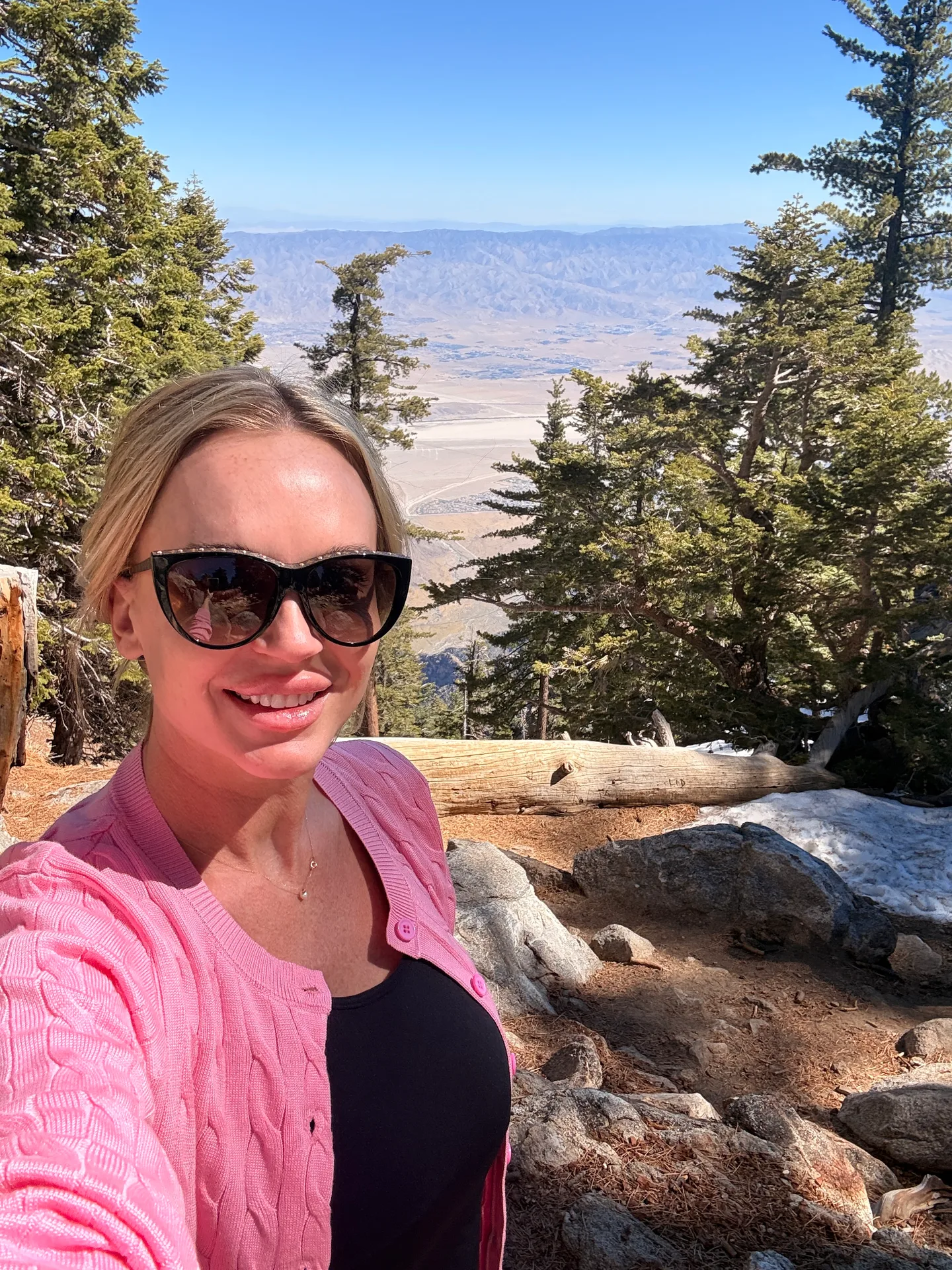 Emily smiling outdoors in the mountains