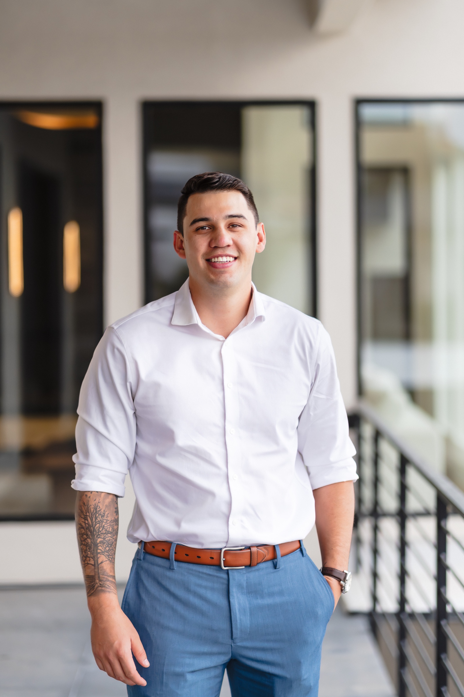 Professional 2026 portrait of Justin Murillo in a white dress shirt, smiling