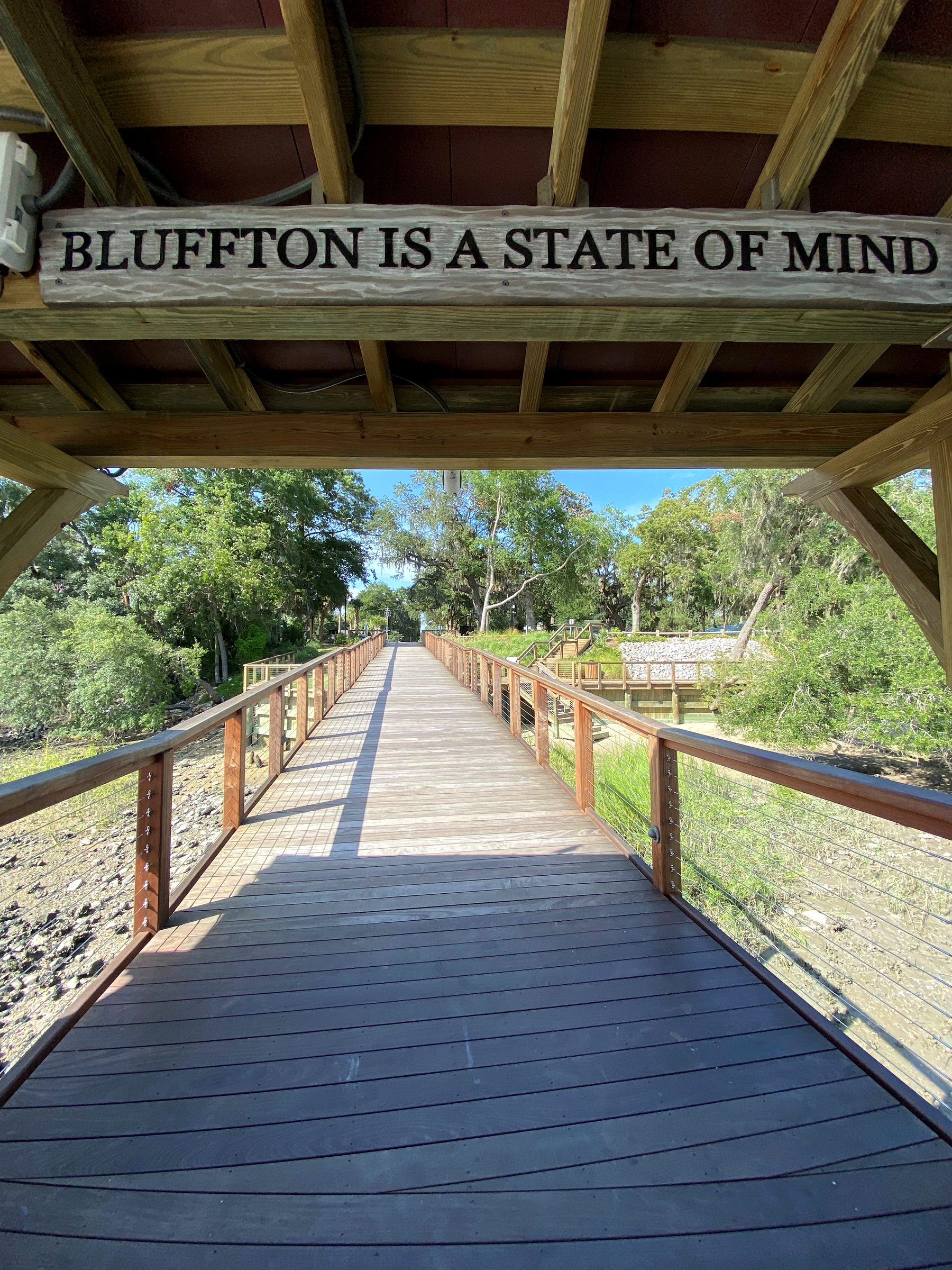 Boardwalk with a 'Bluffton is a state of mind' sign in Bluffton, SC
