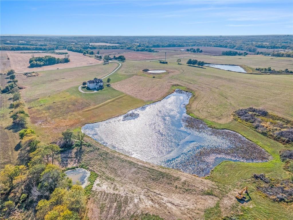 Aerial view of property and pond