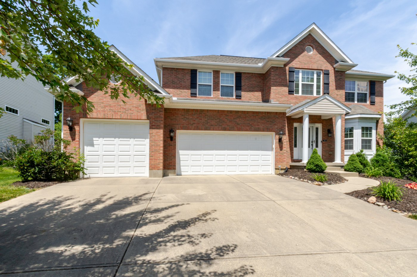 2186 Tourney Trail, Beavercreek, Ohio -- a well-maintained suburban home with manicured landscaping on a sunny summer day