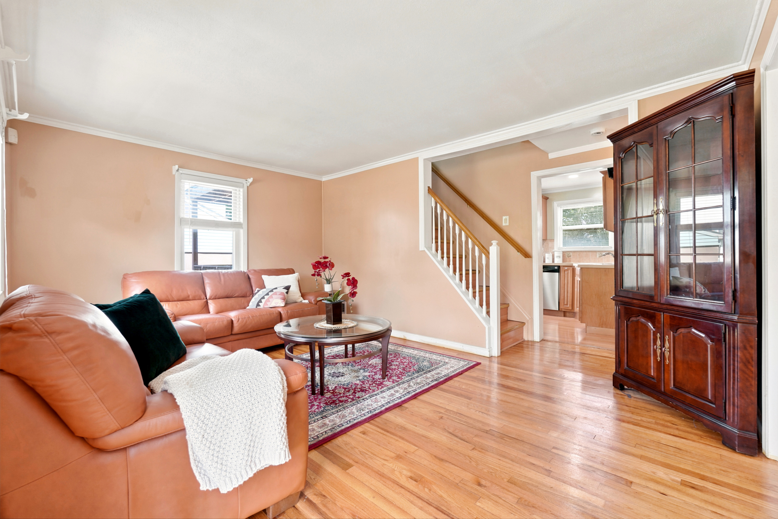 Living room at 50 Heather Ln looking toward the stairs, with wood flooring and a white railing