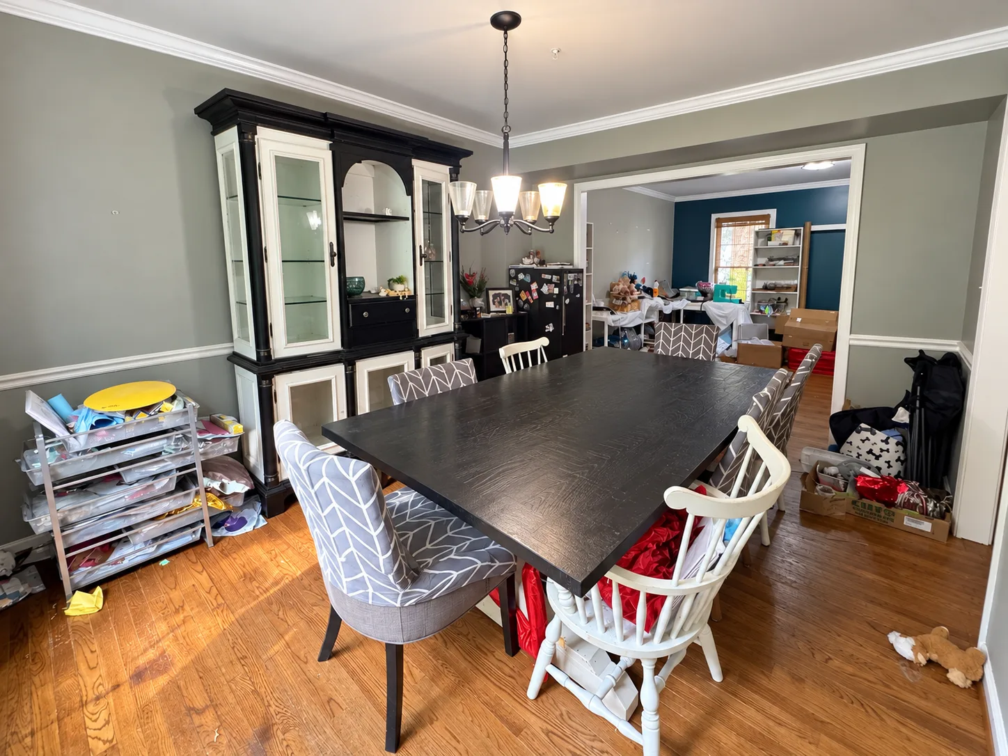 Dining room with a large wood table and a china cabinet in the Summerwood short sale in Stafford VA
