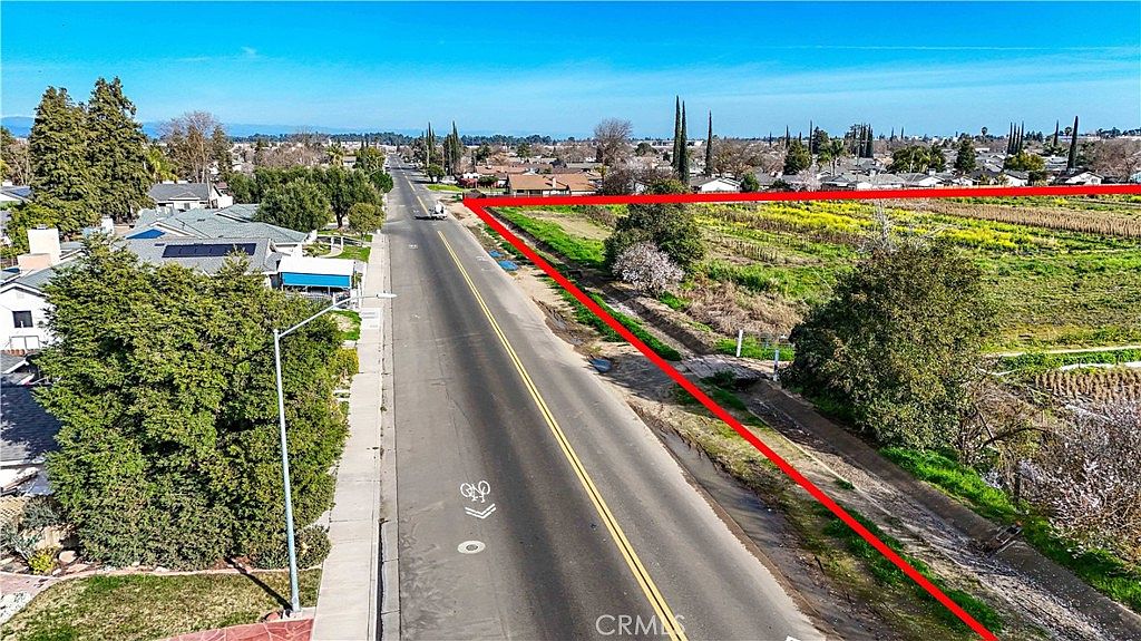 Aerial view of the investment property with surrounding agricultural land