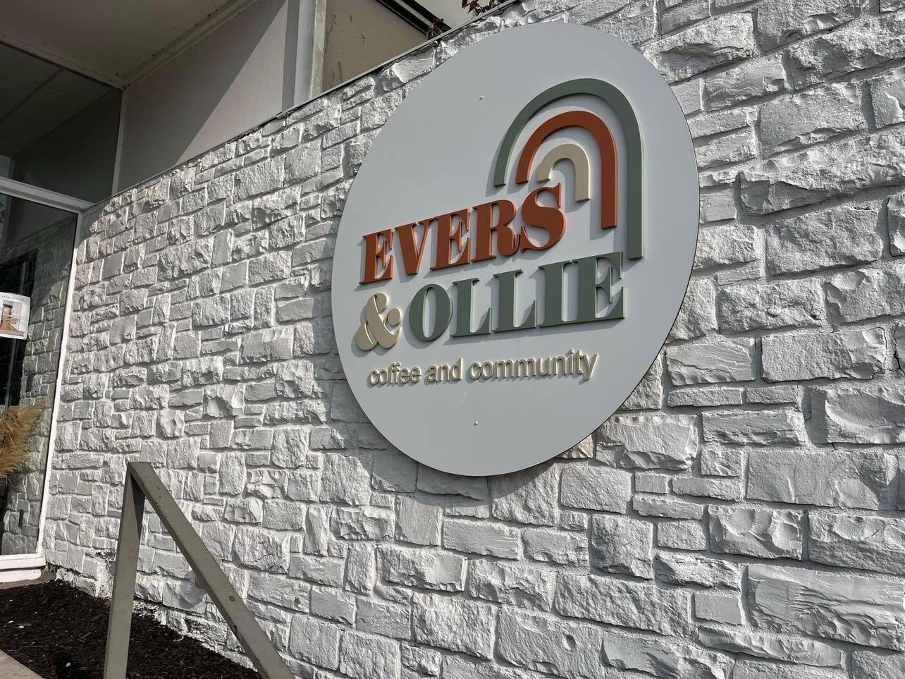 Cozy interior of Evers and Ollie Boutique and Coffee House with warm pendant lighting, curated merchandise, and a welcoming coffee bar in downtown Linden, Michigan