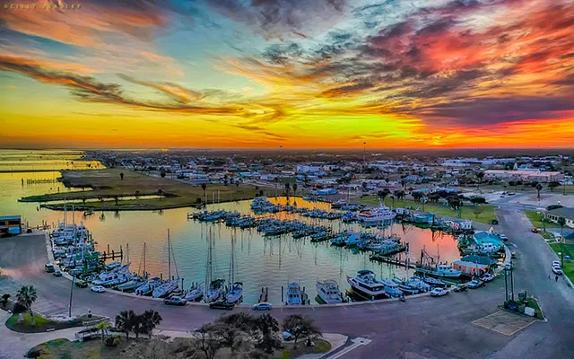 Aerial sunset view of Rockport Harbor with boats docked along the marina