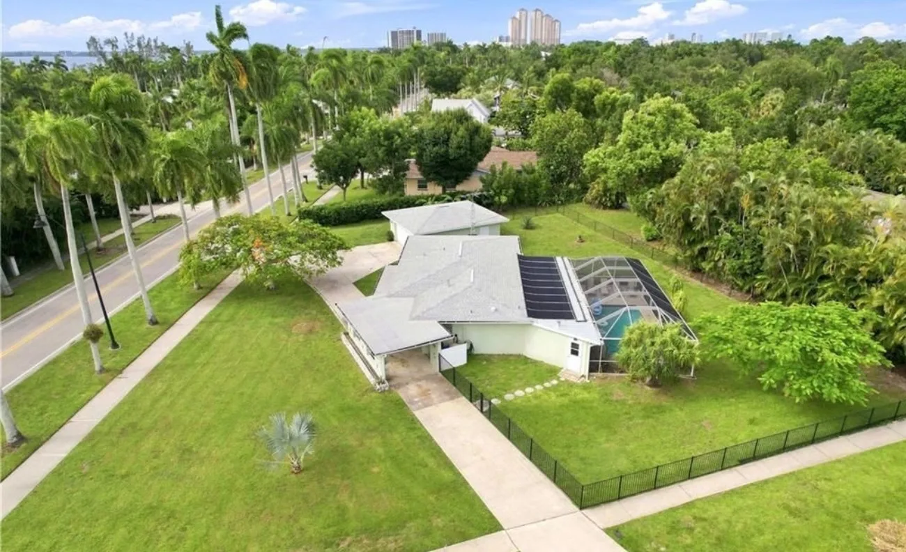 Aerial view of 2741 McGregor Blvd showing the home on its nearly half-acre lot with screened pool, large yard, and mature trees