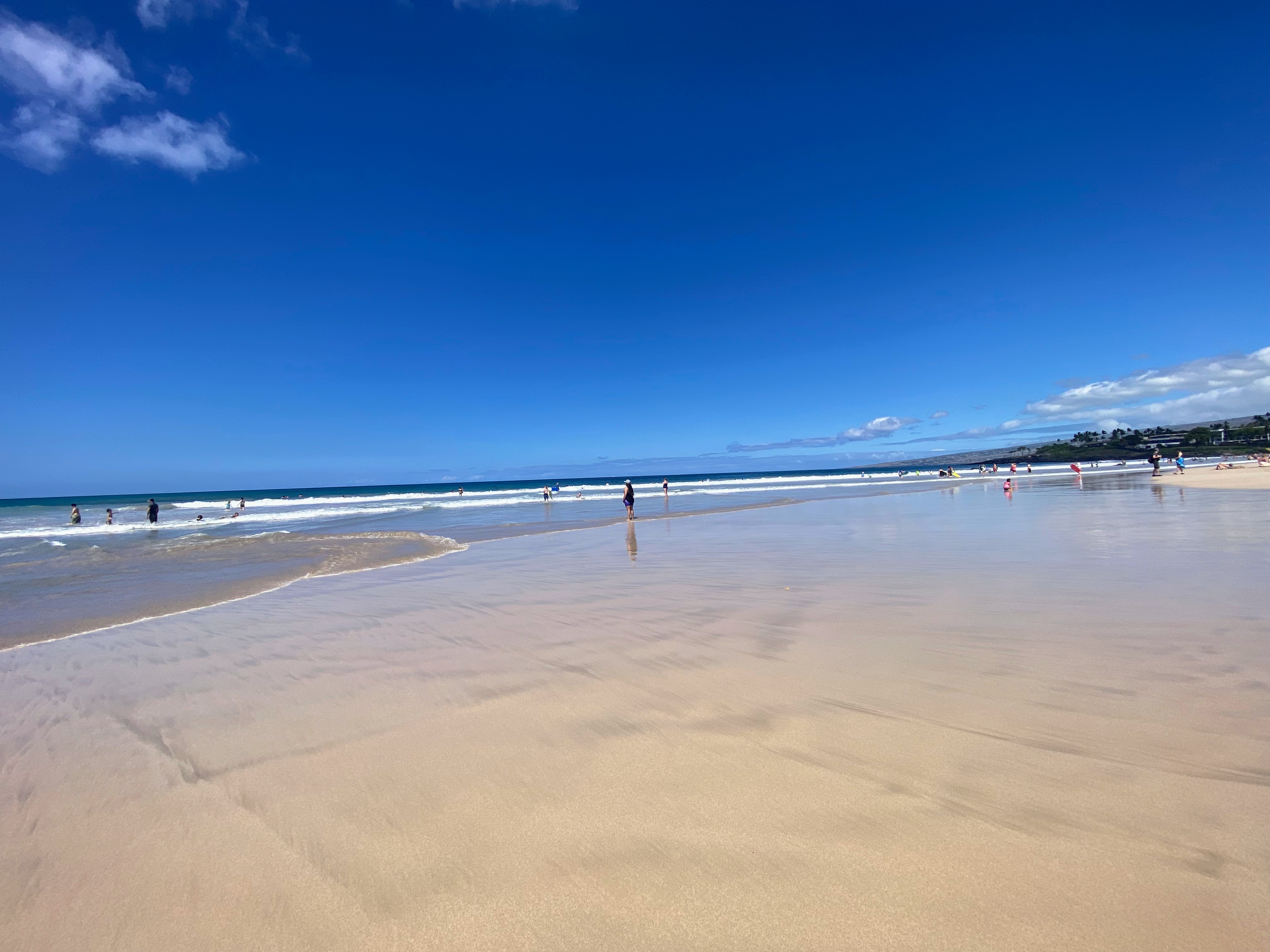 Unobstructed view of Hāpuna Beach from the south end, with Kohala Mountain sloping in the distance
