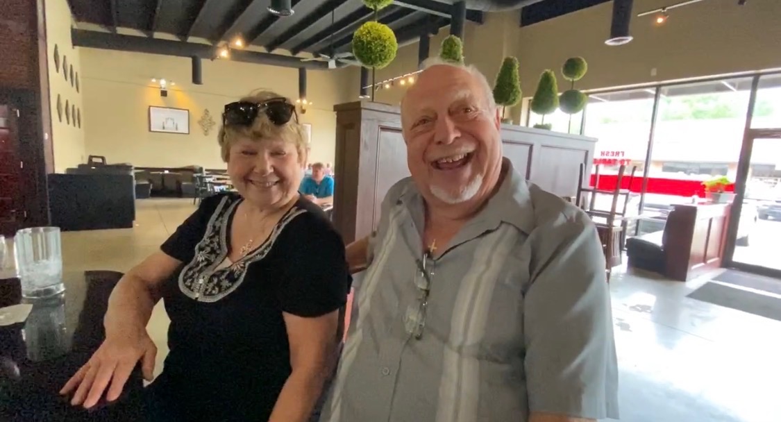 Oz and Linda filming a video review at Maynard's at the Corner BBQ restaurant in Flowery Branch Georgia