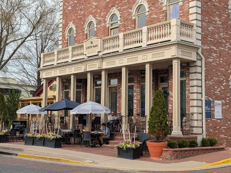 Historic brick-paved Main Street in Zionsville Indiana with shops and fall foliage