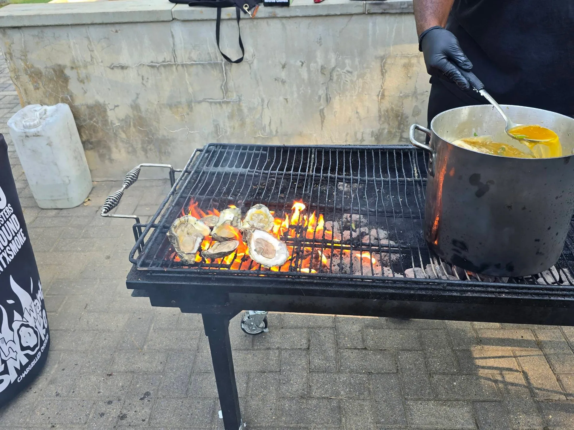 MYSCO Fire Grilled Company cooking fresh grilled oysters and BBQ on the grill at the golf tournament