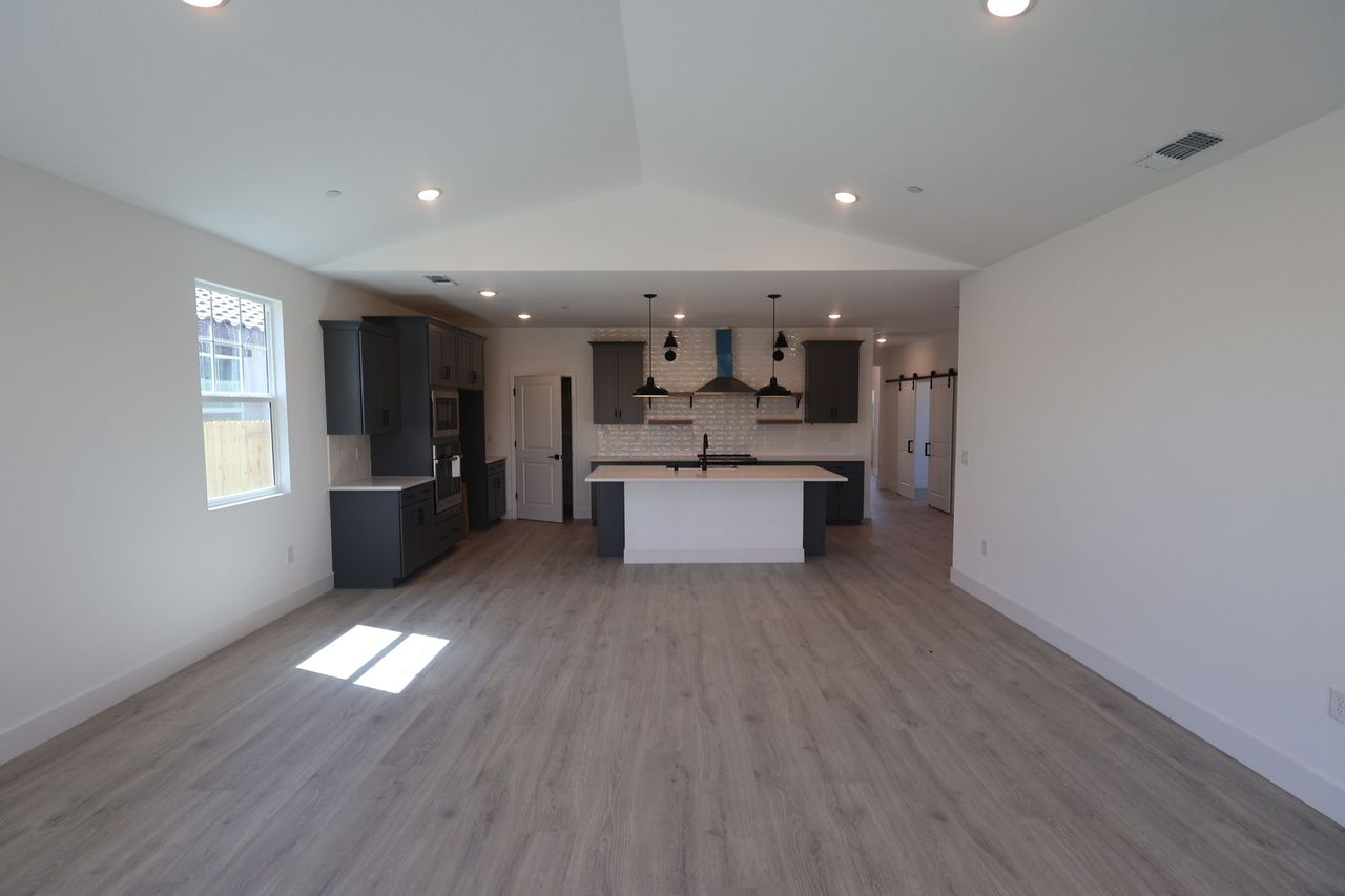 A bright, open great room with a vaulted ceiling in a Four Seasons at The Ranch home in Rancho Cordova, California