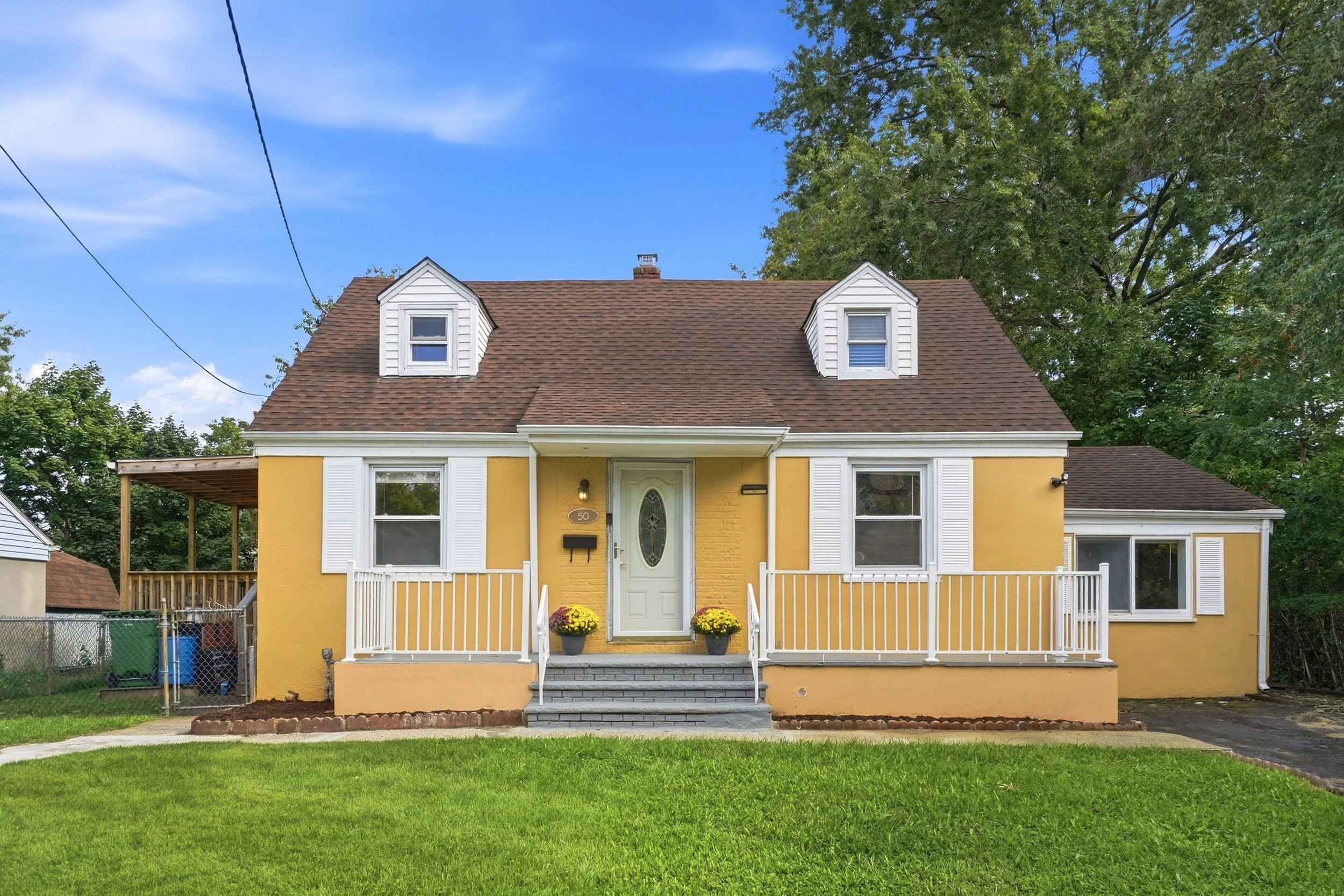 Daytime front exterior of the Cape Cod home at 50 Heather Ln