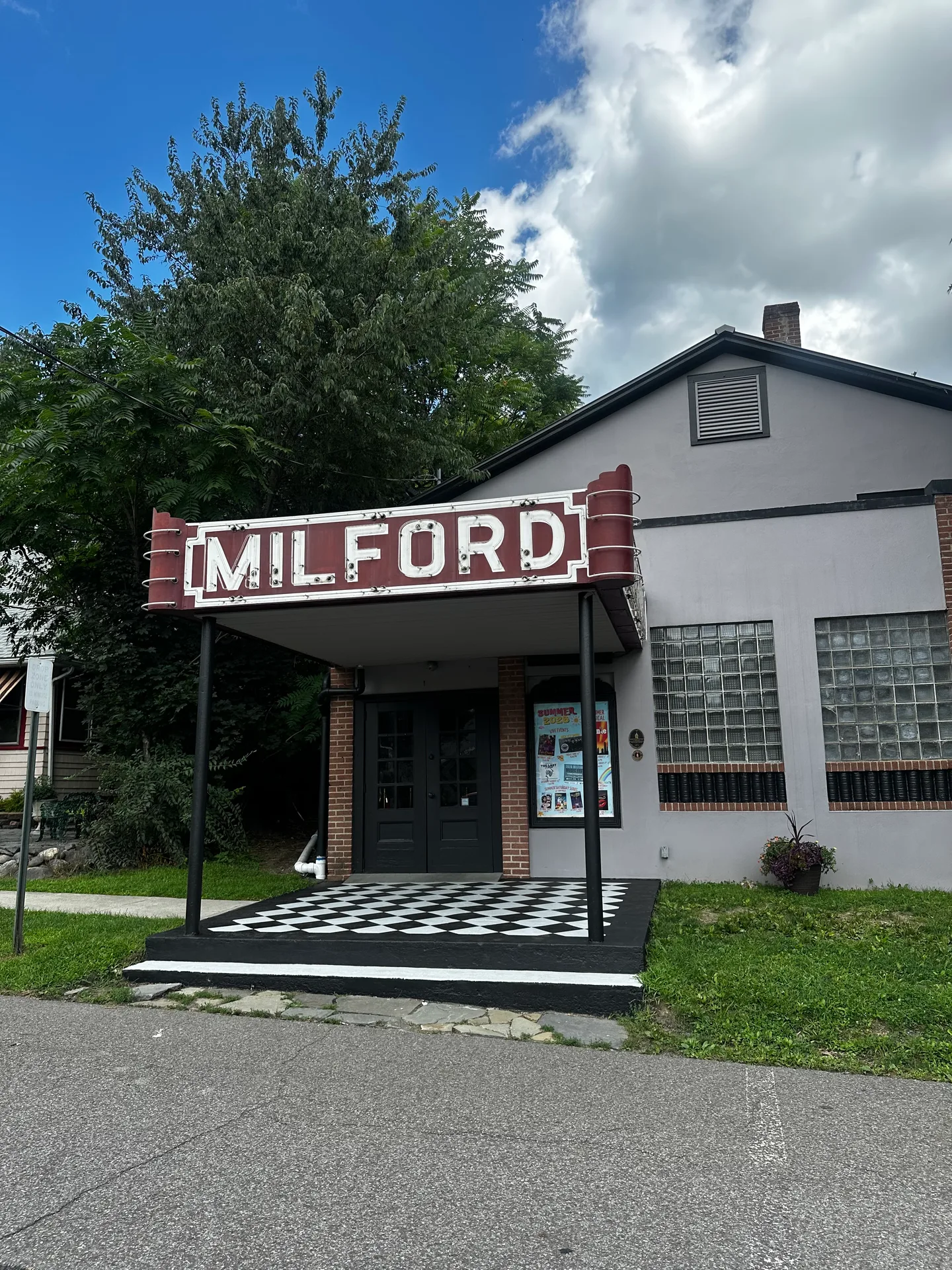 The historic Milford Theater building and its MILFORD sign in downtown Milford, Pennsylvania