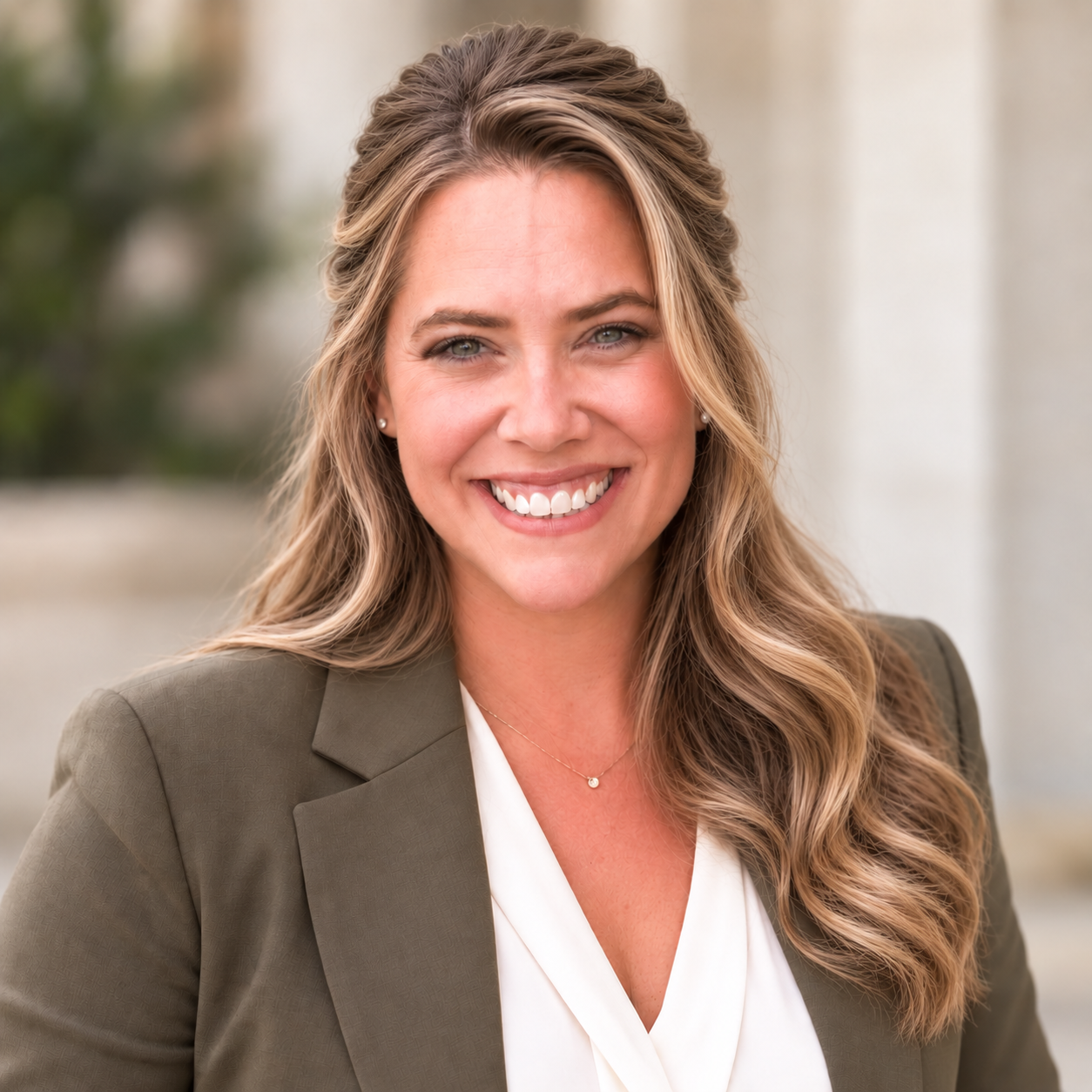 Misty Fisher, Realtor® in Eagle, Idaho, portrait in an olive green blazer