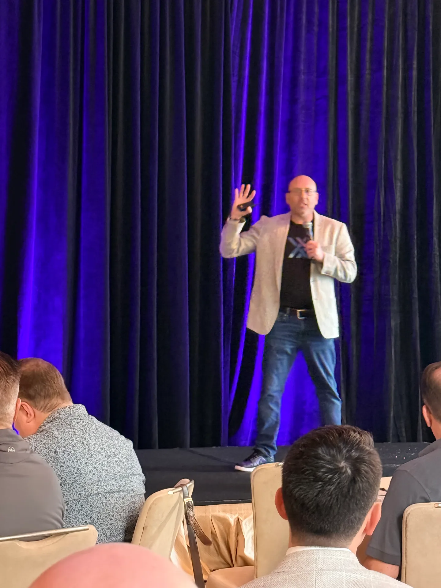 Craig Davis speaking on stage at the Xactus Sales Kickoff in Miami