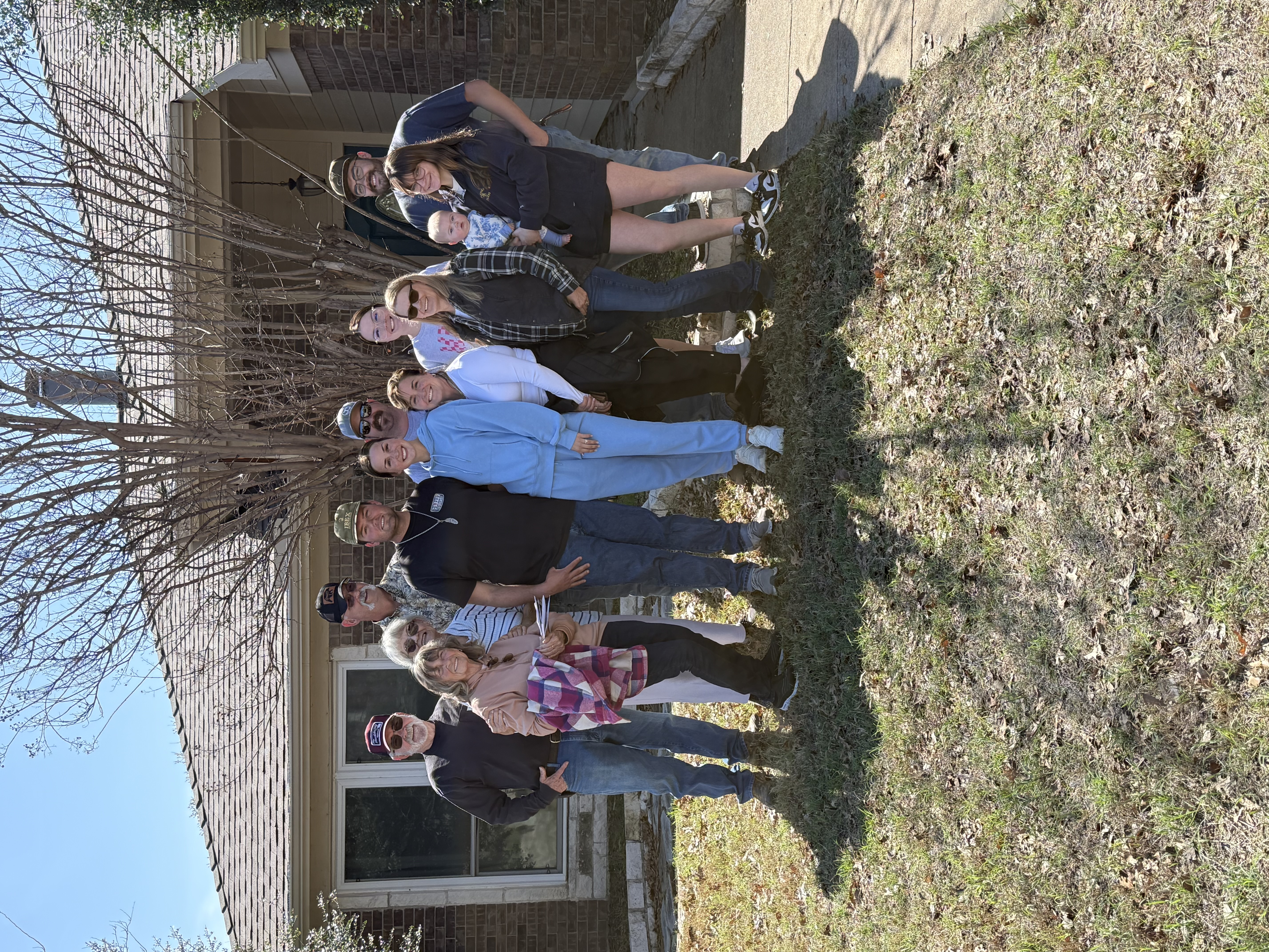 Large group celebration in front of home after closing