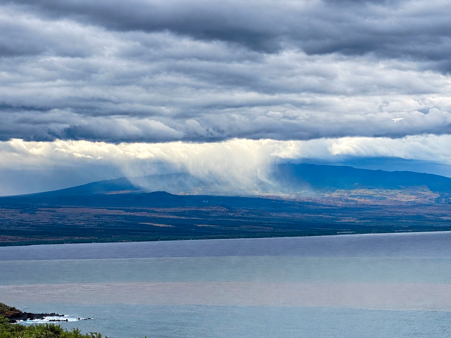 Rain falling over the Kona coast, viewed from the dry side