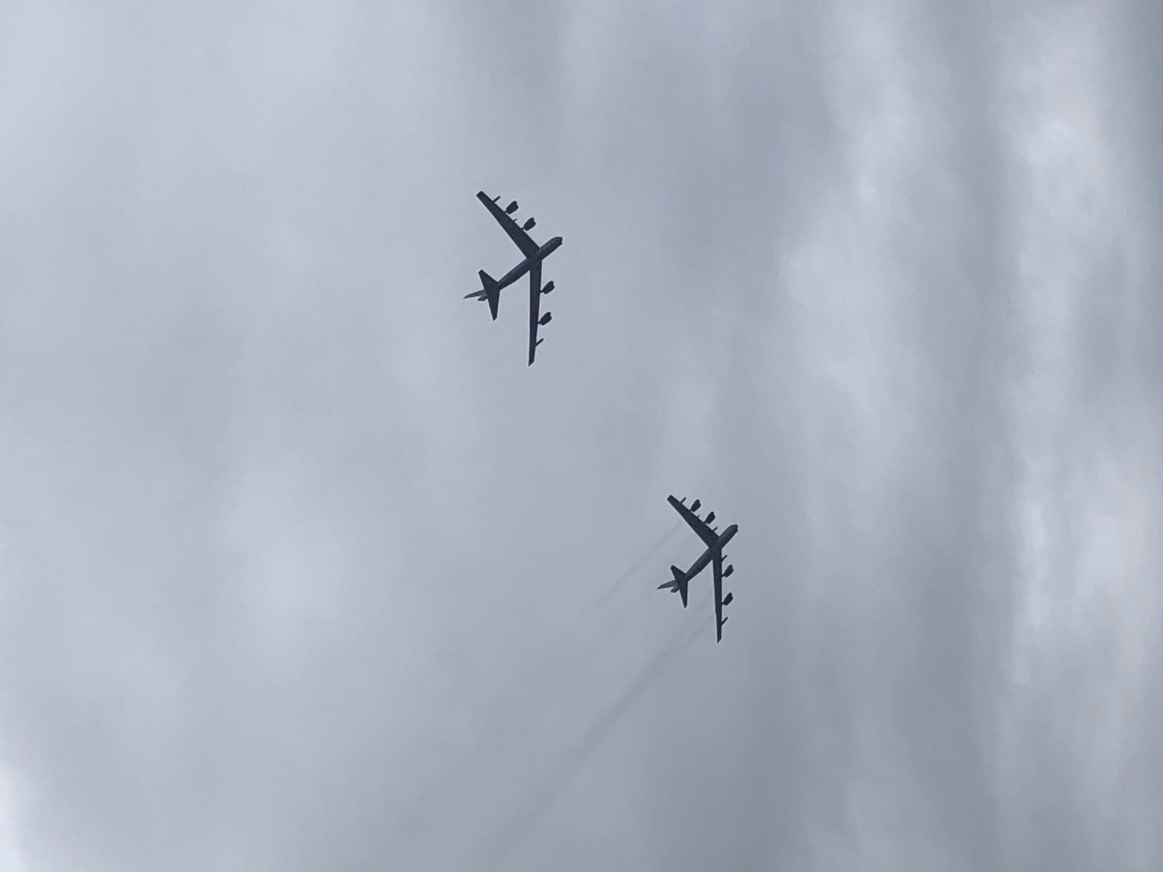 Two B-52 bombers flying in formation against a clear sky
