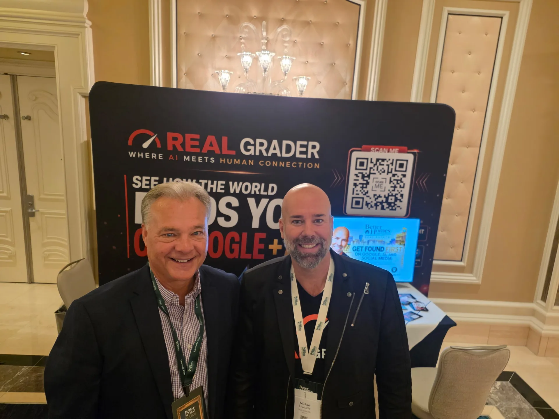 Two attendees stand in front of the Real Grader booth at the Better Homes and Gardens Real Estate retreat