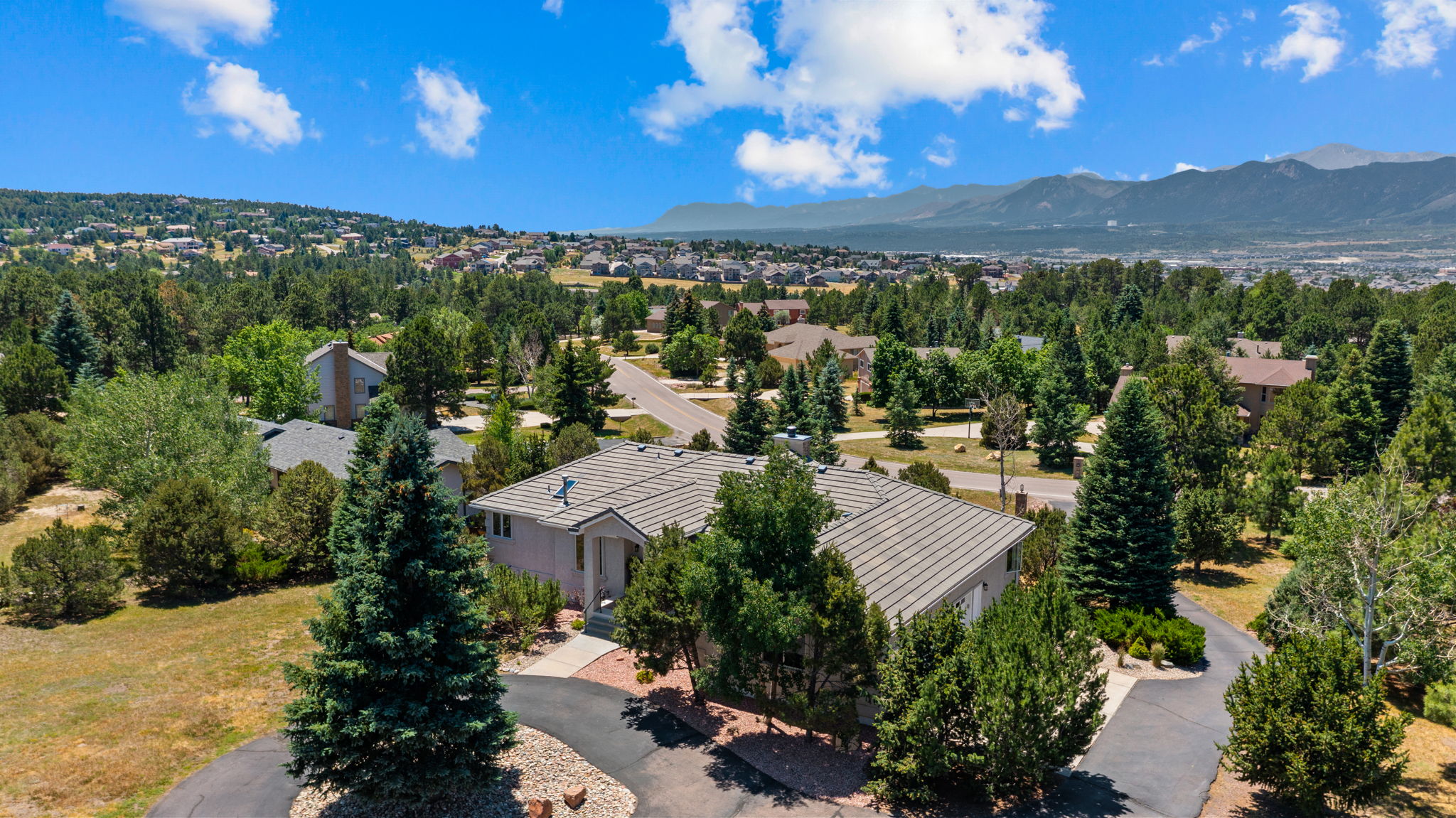 830 Lake Woodmoor in Monument, Colorado — custom walkout ranch with Pikes Peak views