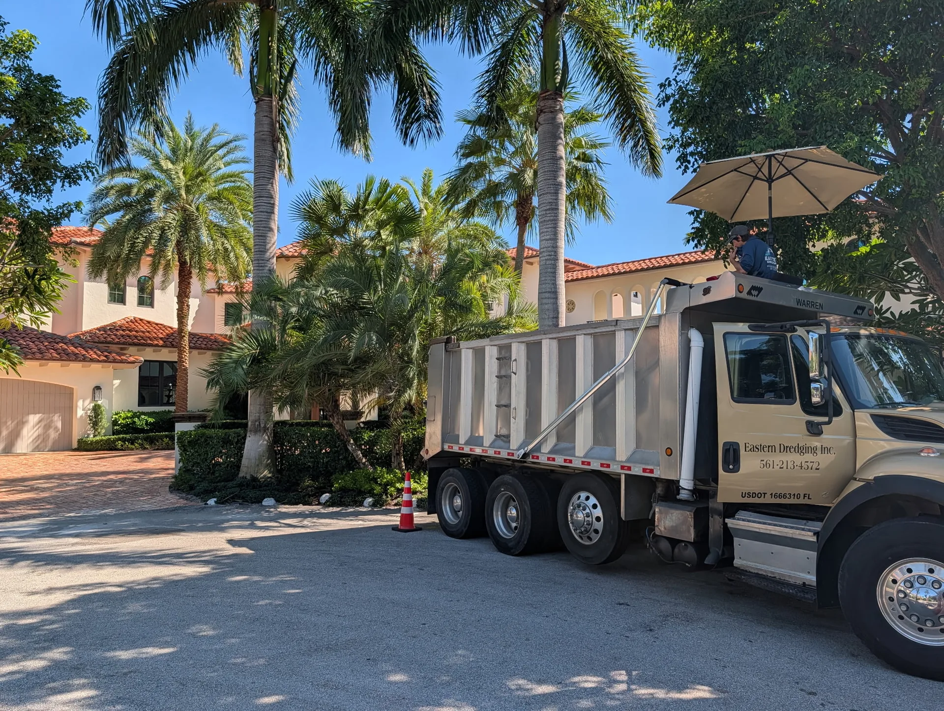 Eastern Dredging truck parked in front of a house