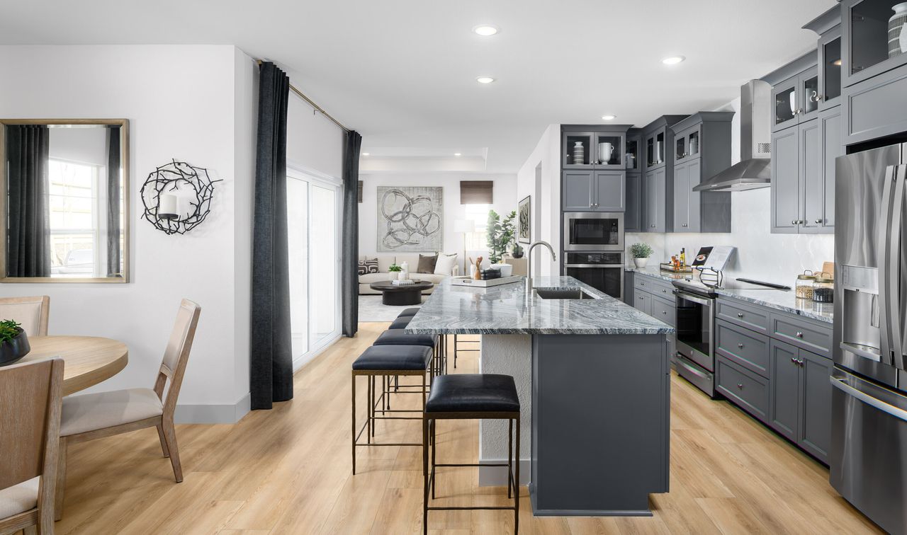 The open-concept kitchen and dining area of the Raven plan at Four Seasons at The Ranch in Rancho Cordova, California