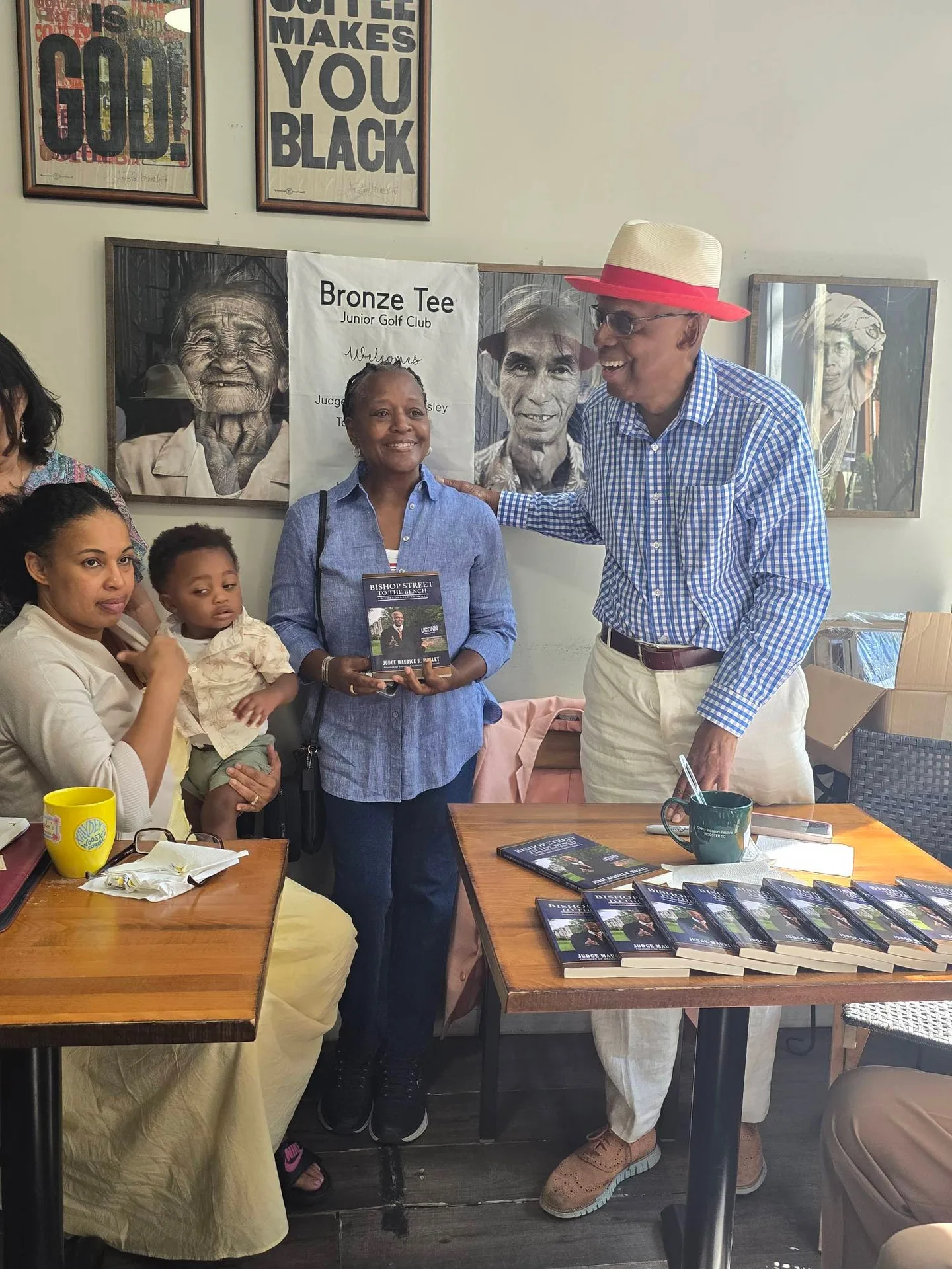 A guest holding up a copy of the book beside the author