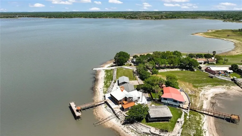 Aerial view of Emily's lakefront property on a point at Lake Corpus Christi, with docks reaching out into the water