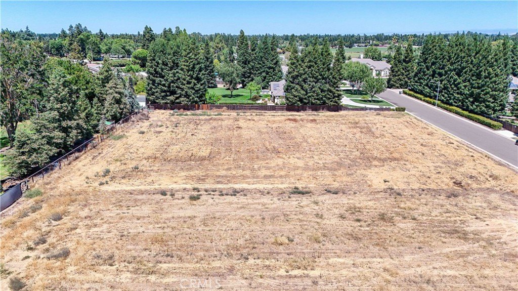 Street-level view of the building lot at 1371 Shady Cove Ave showing the subdivision setting with street lights