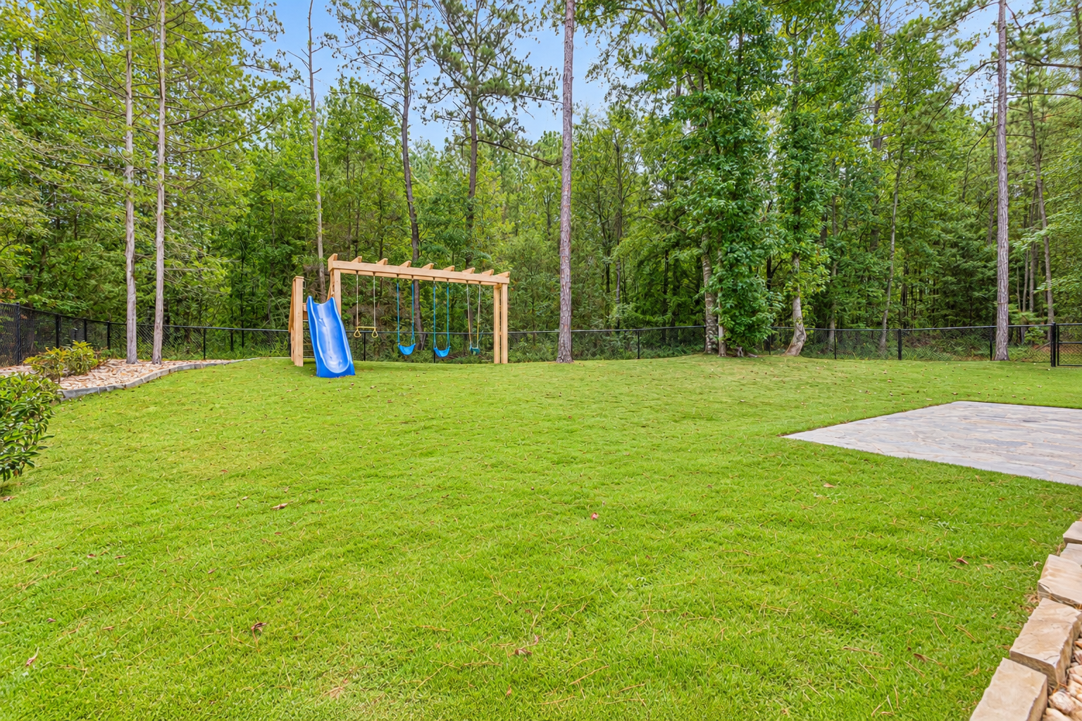Bright woodland backyard at 1537 Dartmouth Dr, Auburn AL
