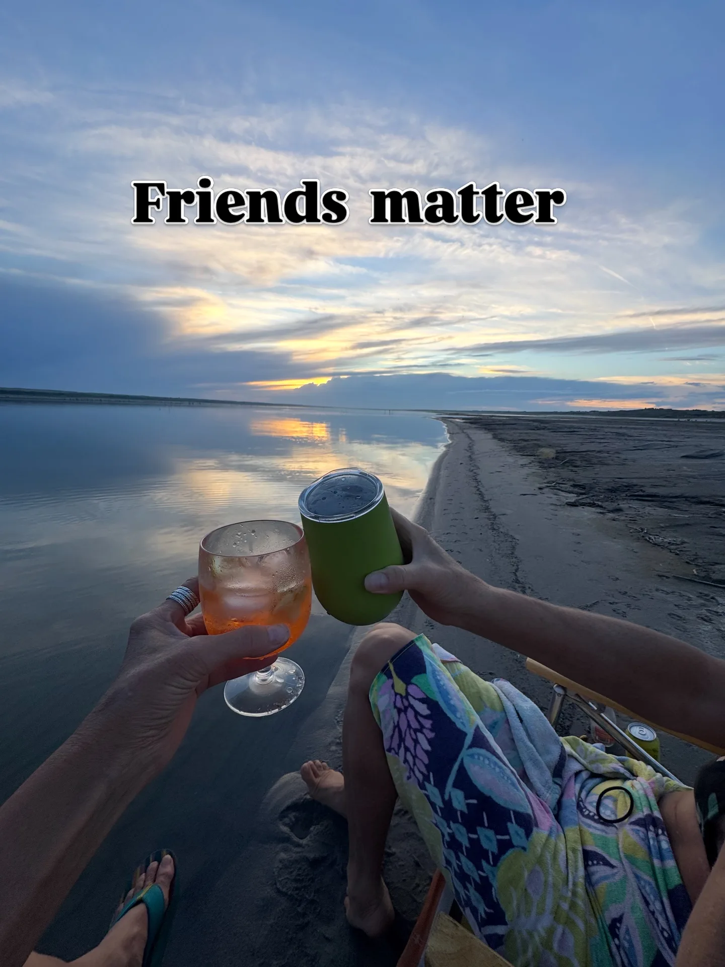 The wide white sand beach of Lake McConaughy in Nebraska meeting clear turquoise water at golden hour