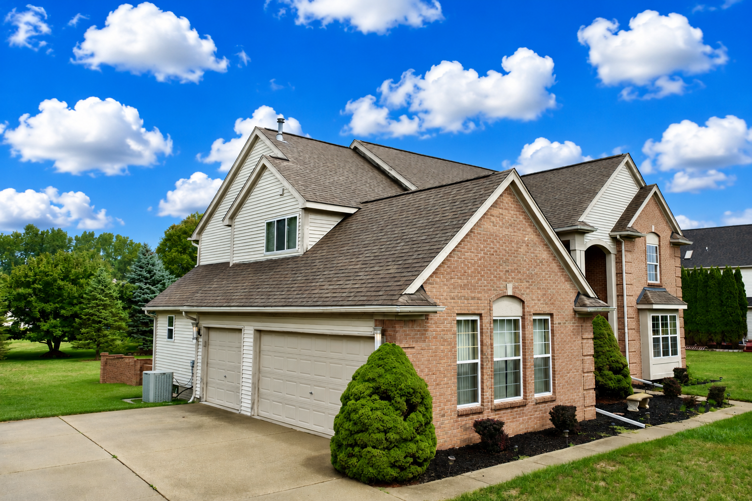 Driveway side of the home at 2295 Hidden Forest Drive, Grand Blanc, Michigan