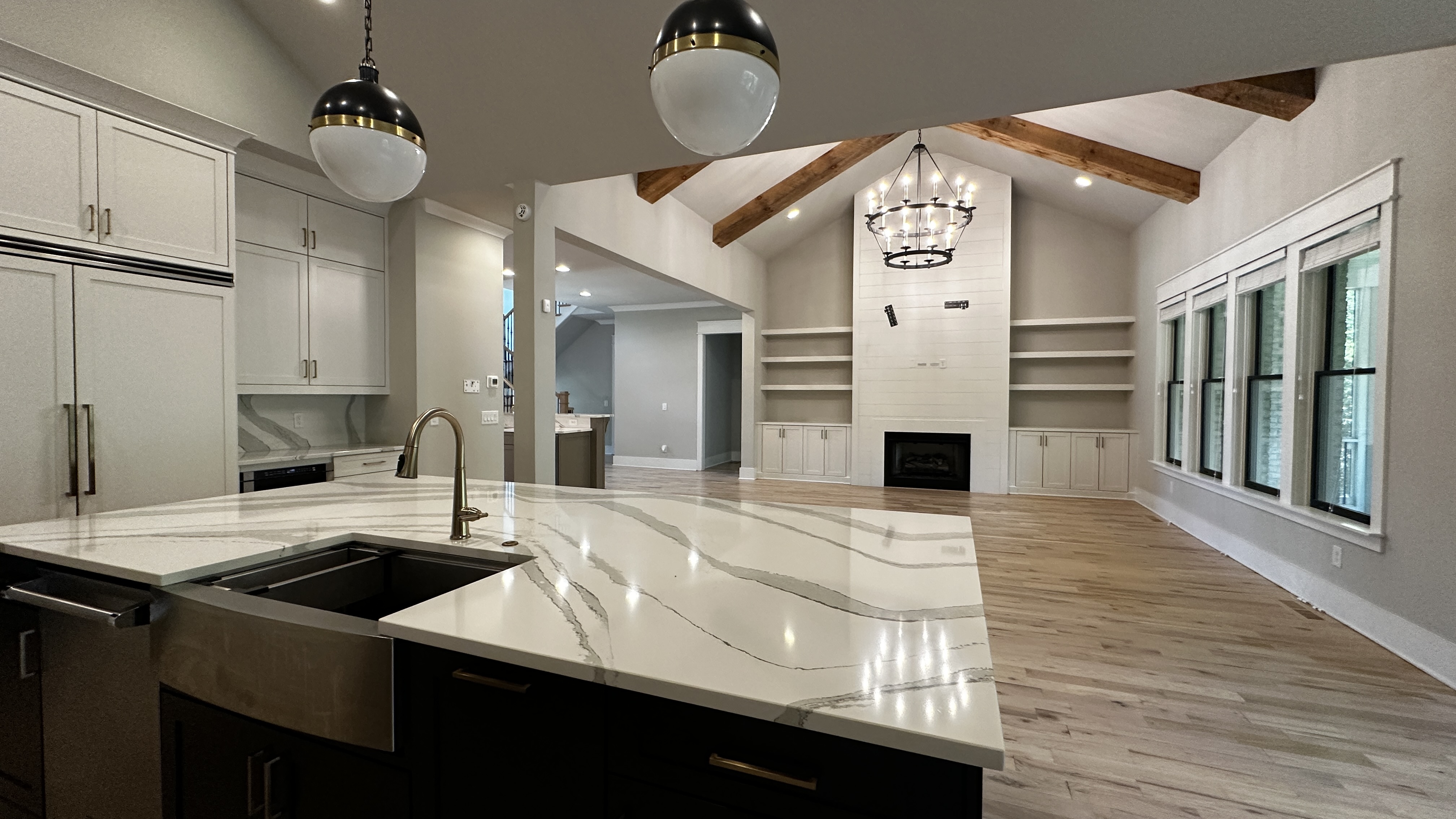 Kitchen and living area at 5760 Lula Bridge Ct with stone fireplace and built-in shelving