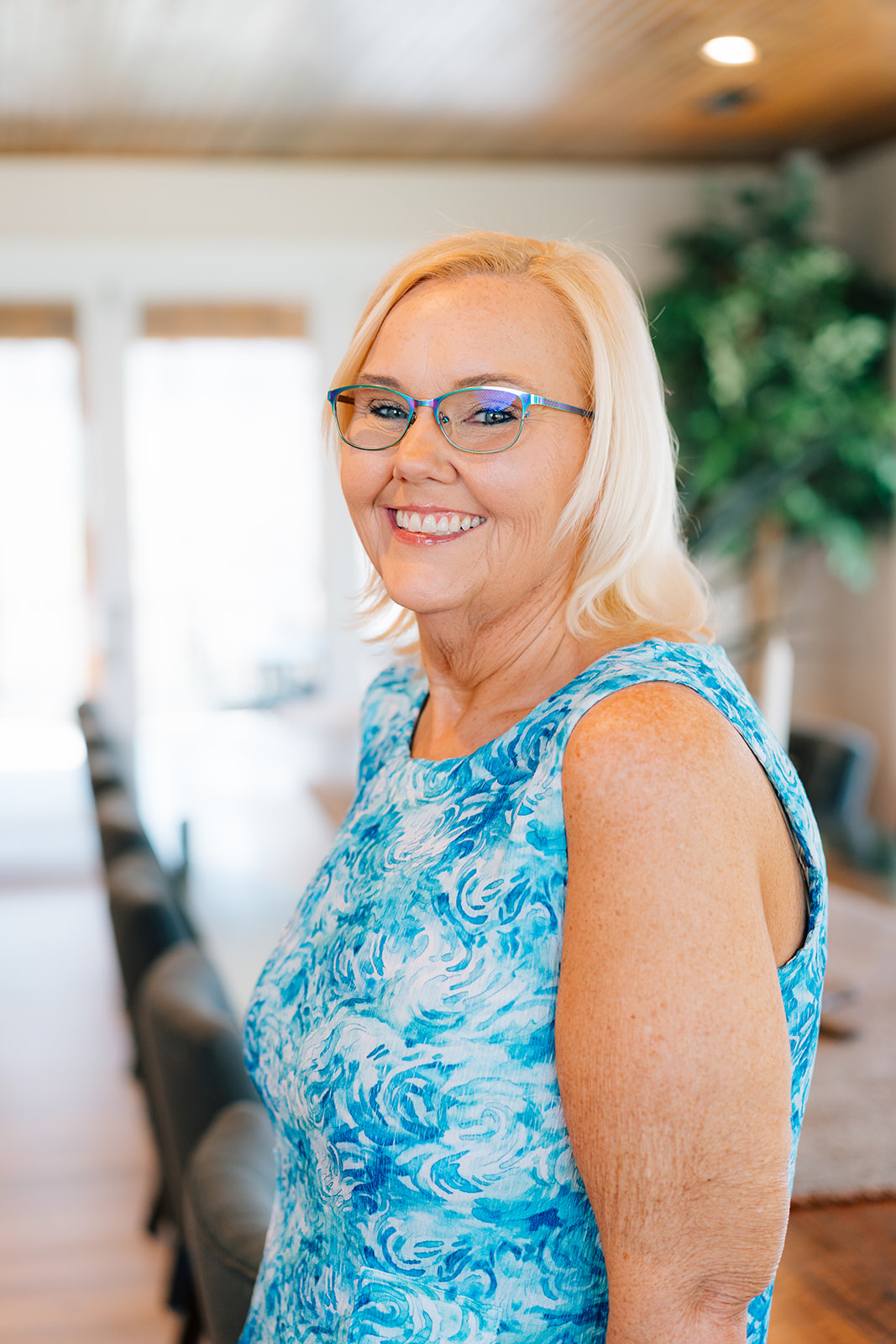 Renee Hackett, real estate consultant, smiling in a home dining room setting