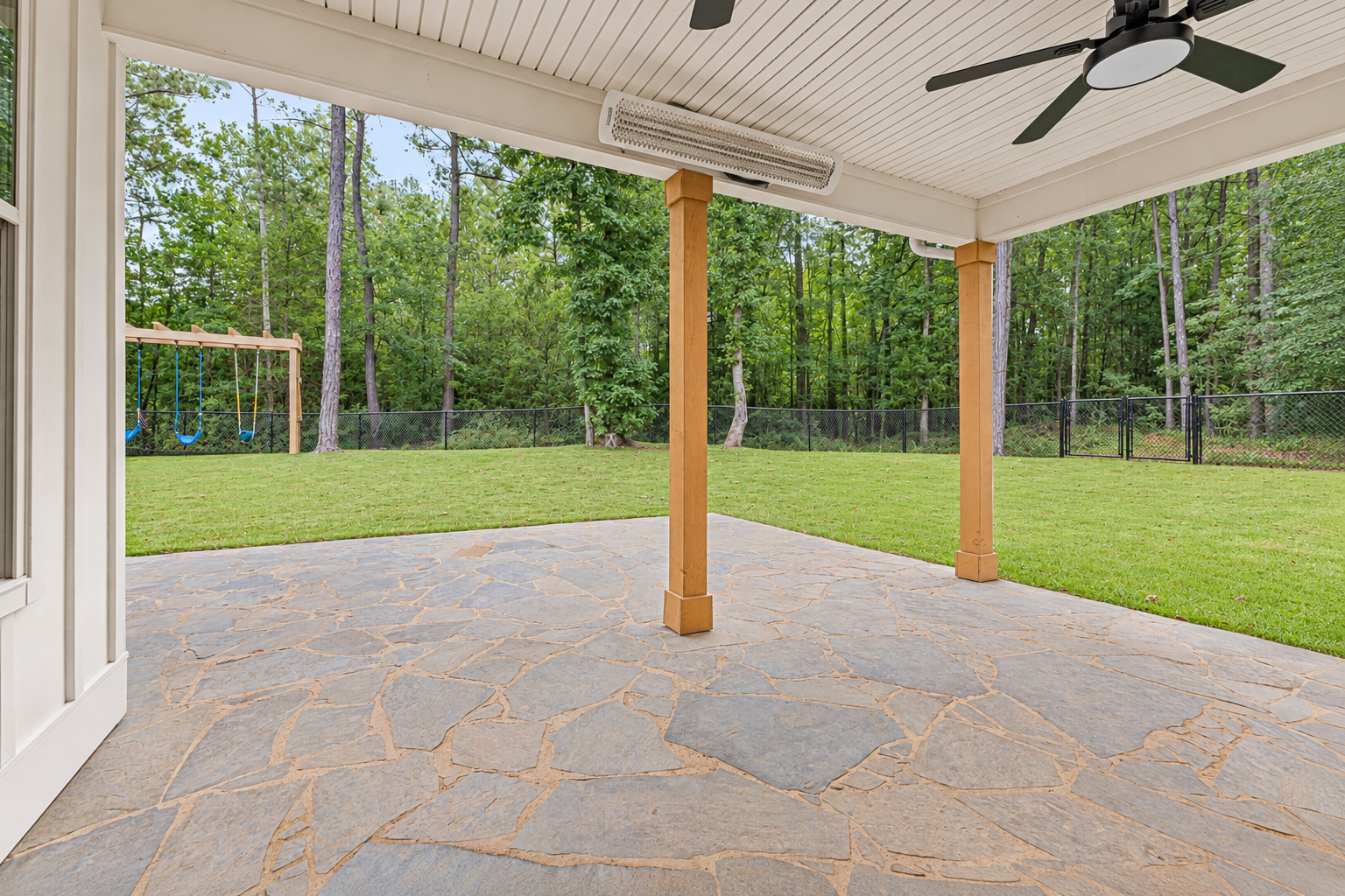 Covered patio overlooking a lush yard at 1537 Dartmouth Dr, Auburn AL