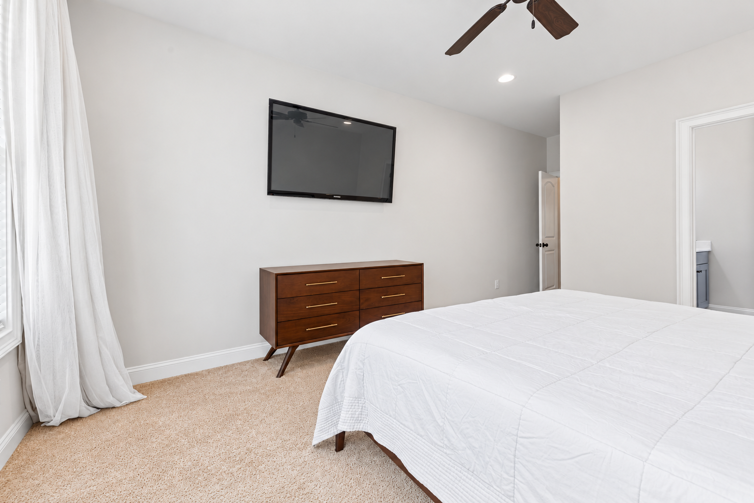 Minimalist bedroom with walnut details at 1537 Dartmouth Dr, Auburn AL