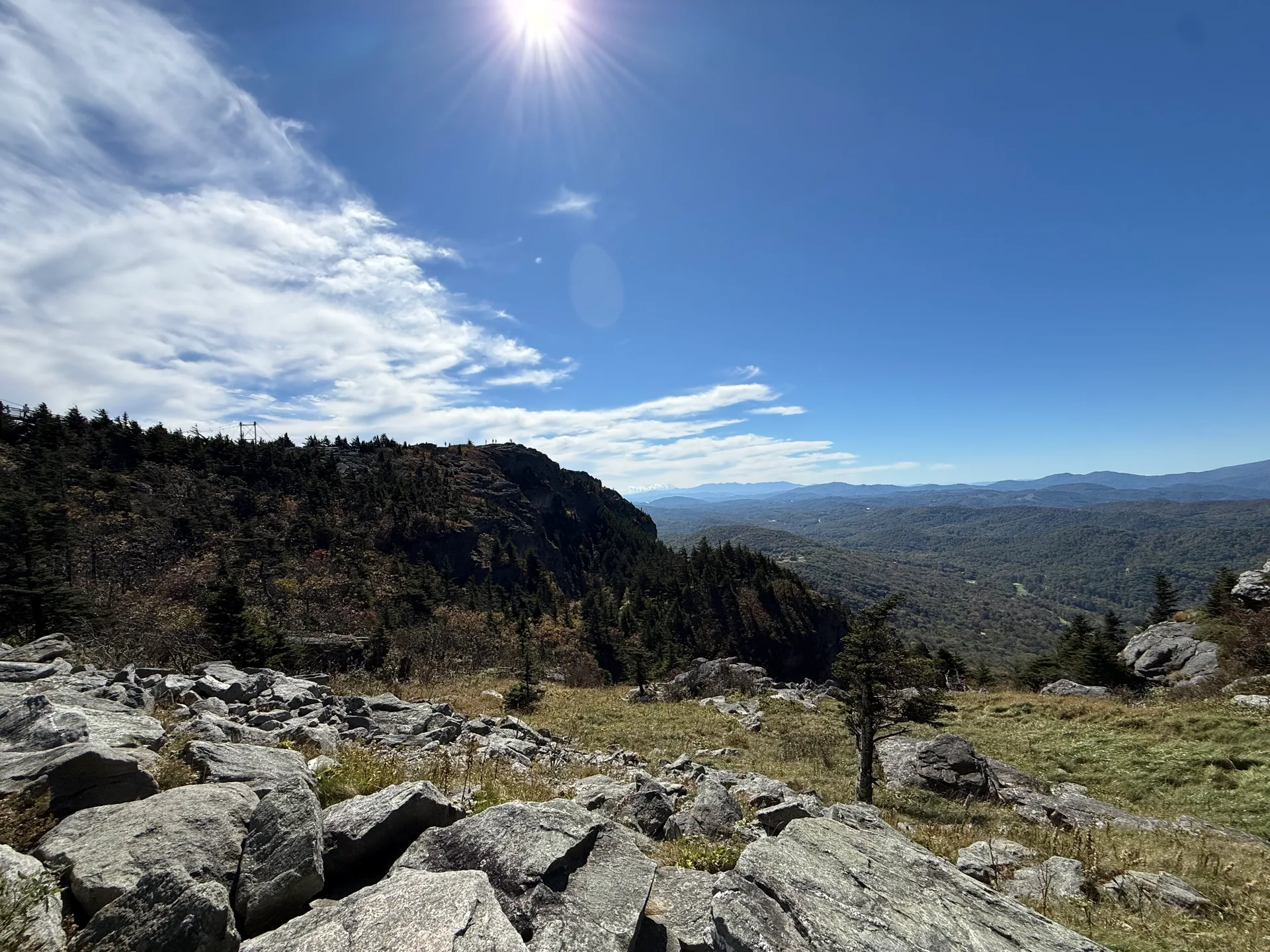 A sunny high-altitude panorama from Grandfather Mountain over wide mountain views