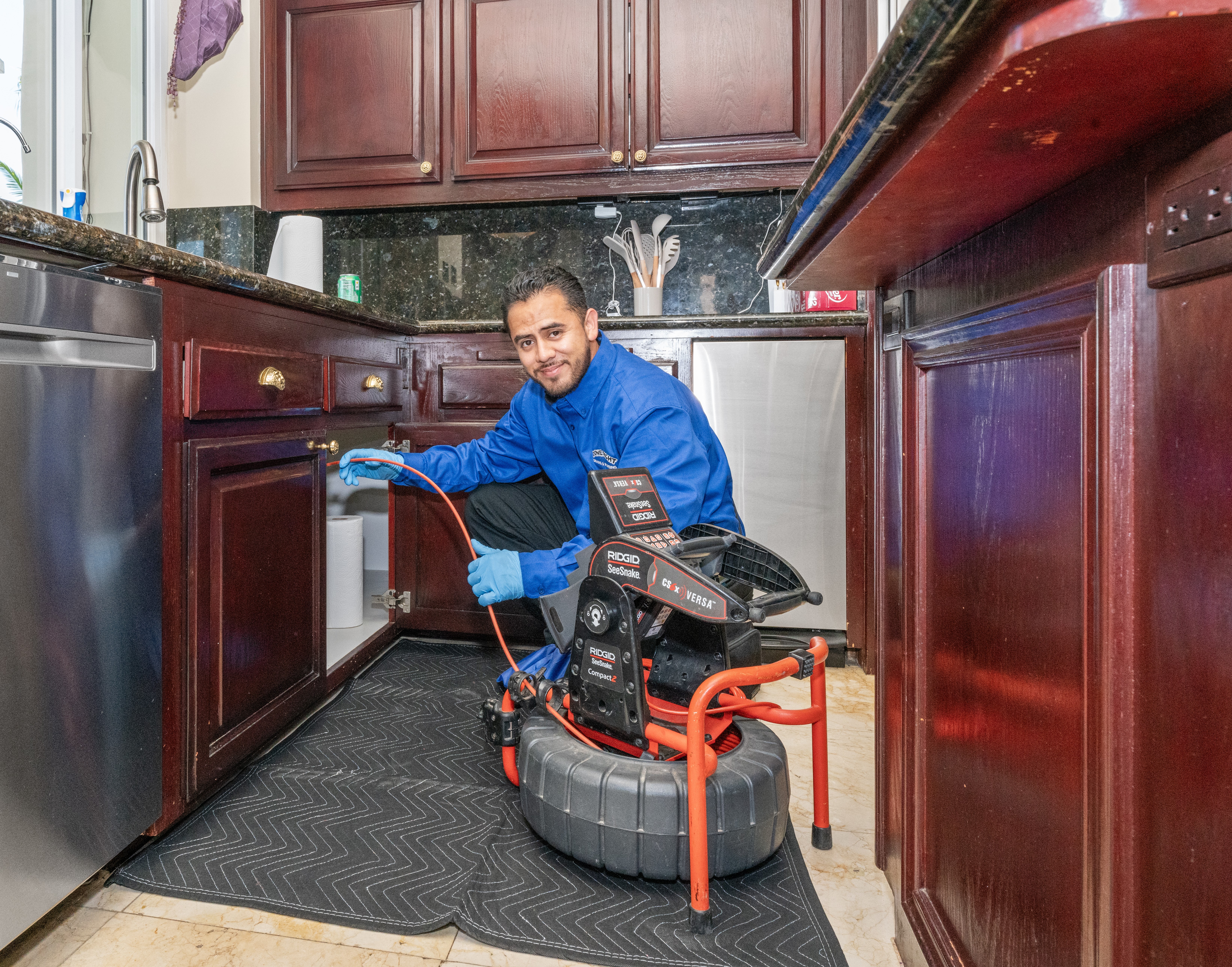 A Done Right Drains And Plumbing technician performing drain service