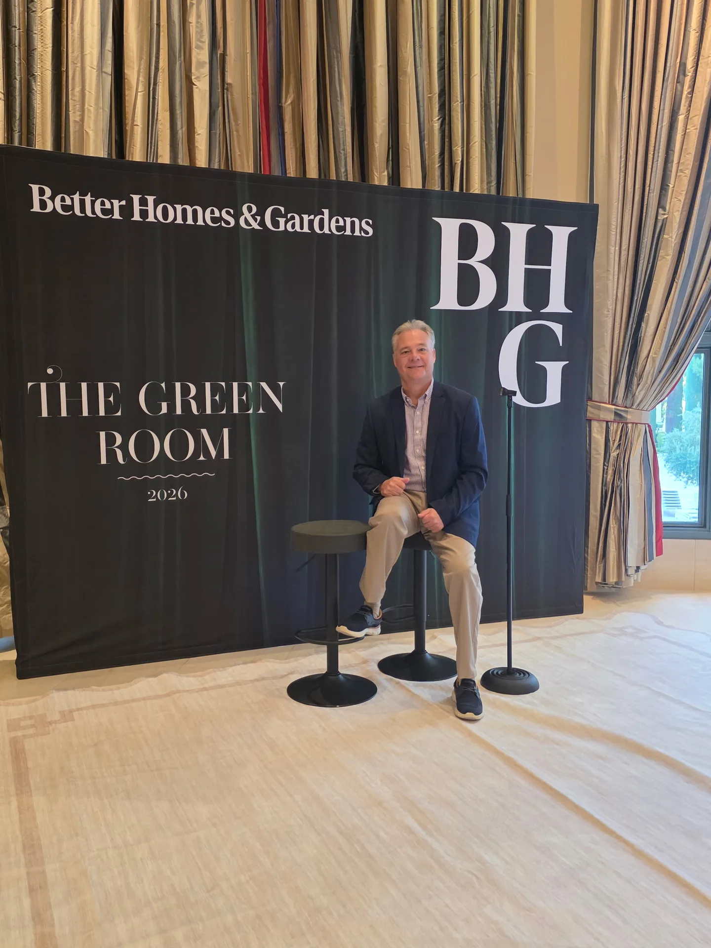 Tim Tepes seated in front of The Green Room 2026 banner at the Better Homes and Gardens Real Estate retreat in Las Vegas