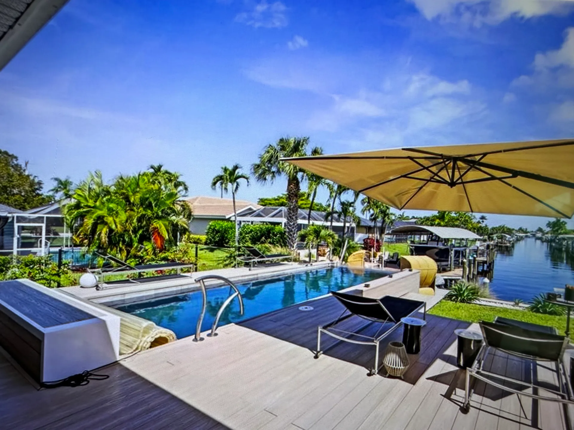 Pool and canal waterfront view at 1933 Cornwallis Pkwy, Cape Coral