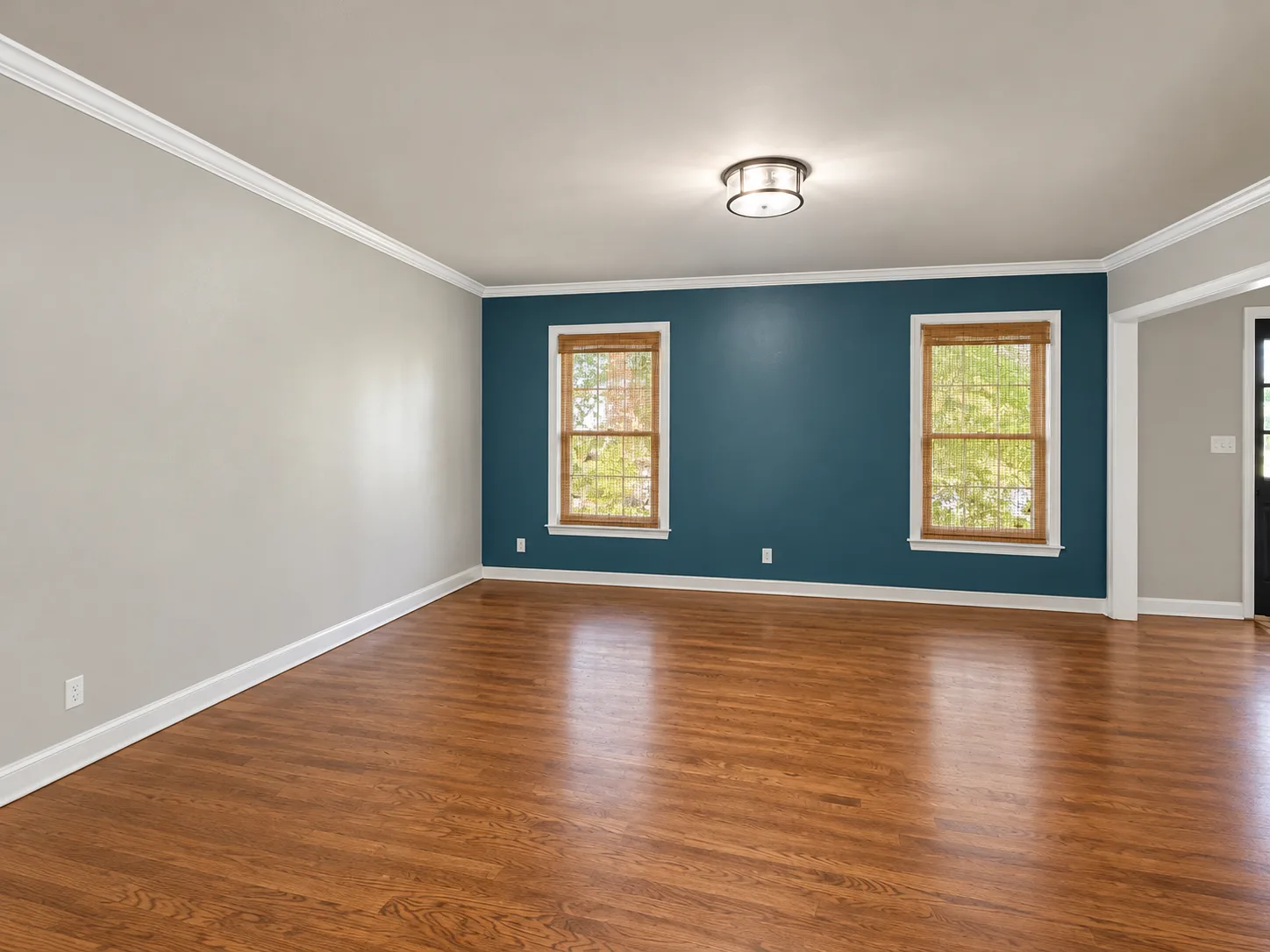 A room with hardwood floors and a blue accent wall in the Summerwood short sale in Stafford VA