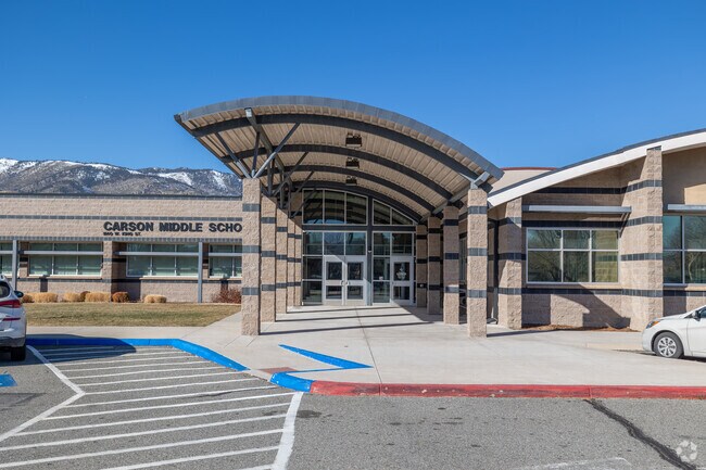 Carson Middle School in Carson City, a modern two-story beige and green school building with flagpole out front.