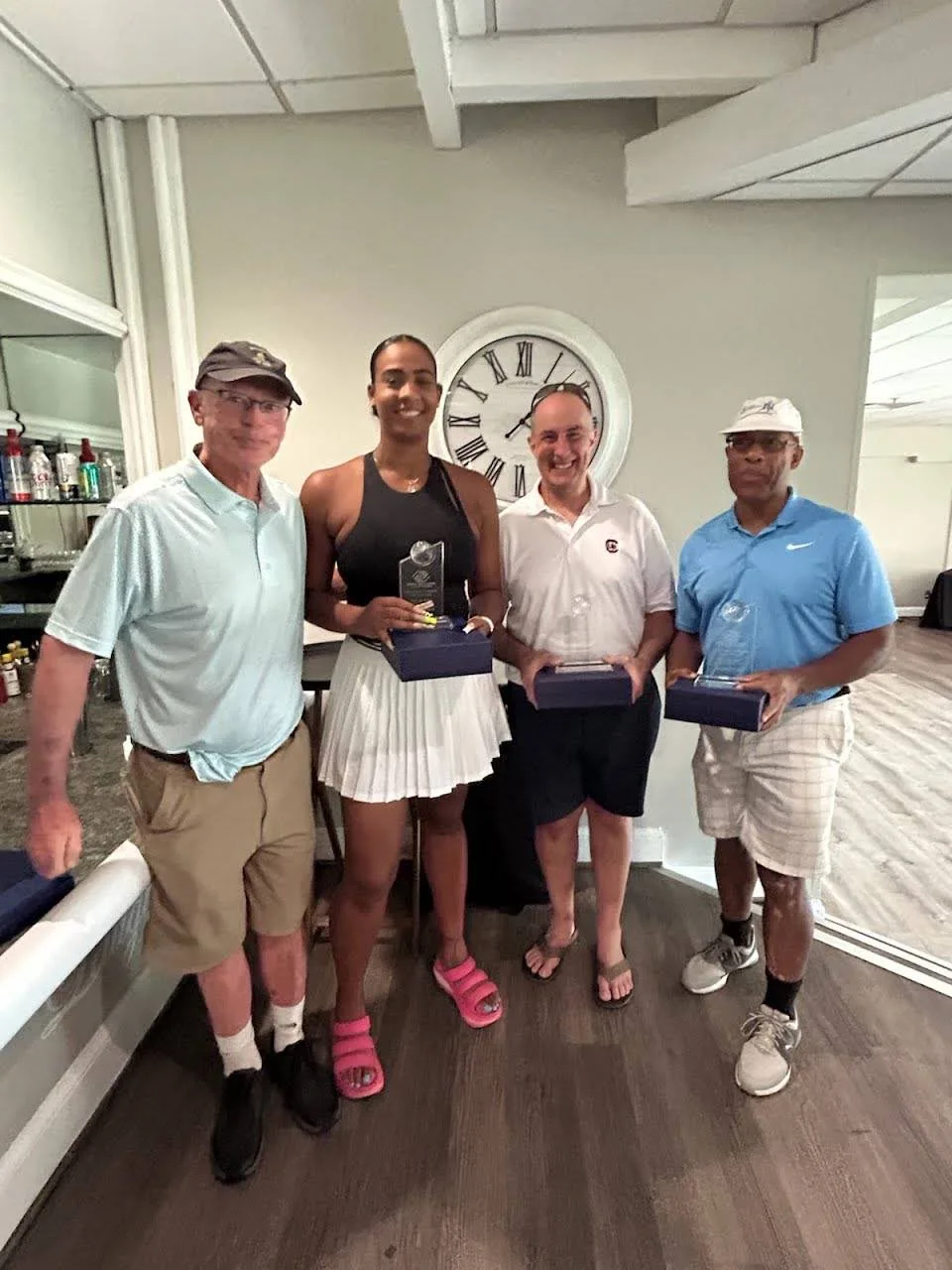 Group of award winners with Boys and Girls Clubs of America trophies at the FORE the KIDS Golf Tournament