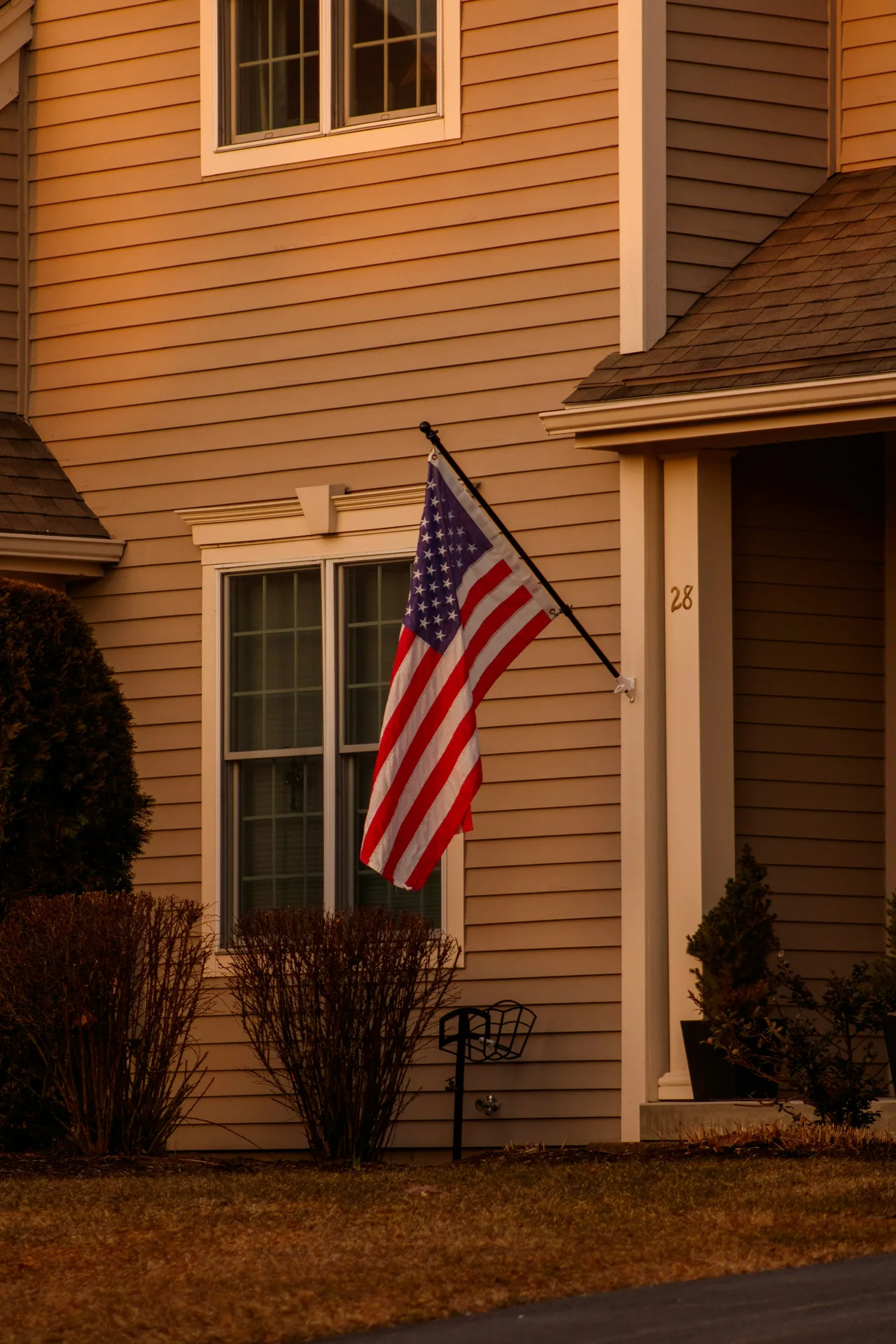 A welcoming home with beige siding and an American flag mounted near the front porch, ready for a military family PCS move to Beale AFB