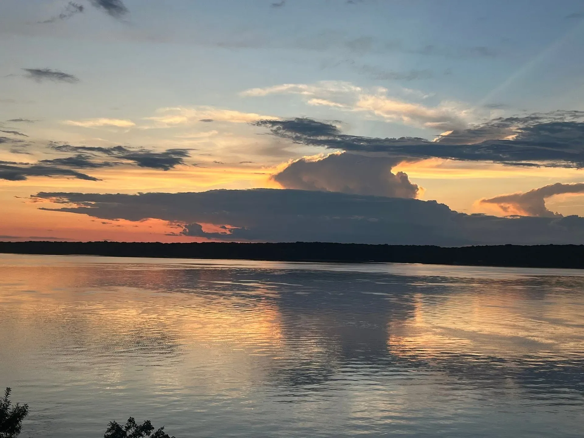 Sunset over a calm stretch of Lake Hudson water
