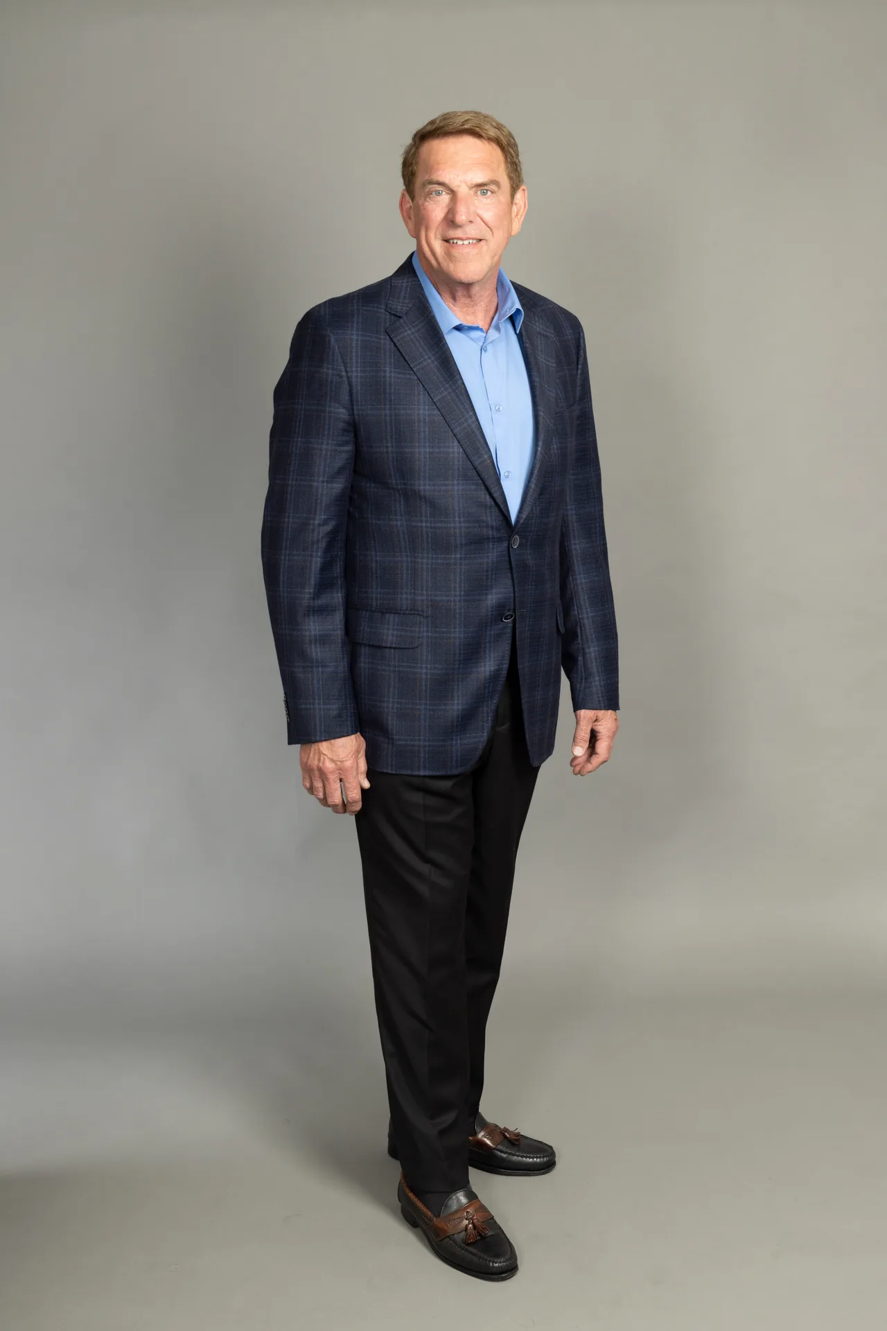 Full-length portrait of Tim Fiebig, Castro Valley real estate agent, in a navy plaid blazer