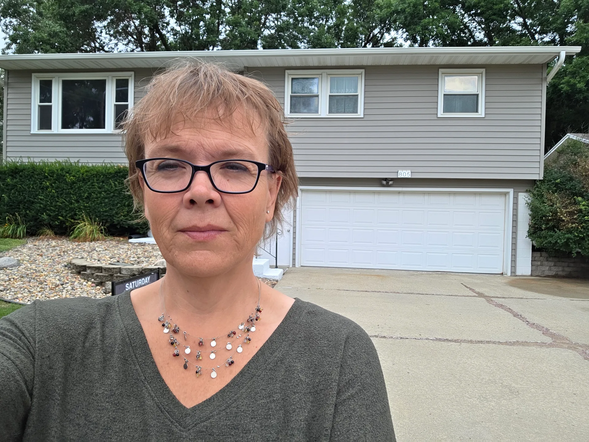 Jennifer Krosch in front of a residential home in the Sioux Falls area