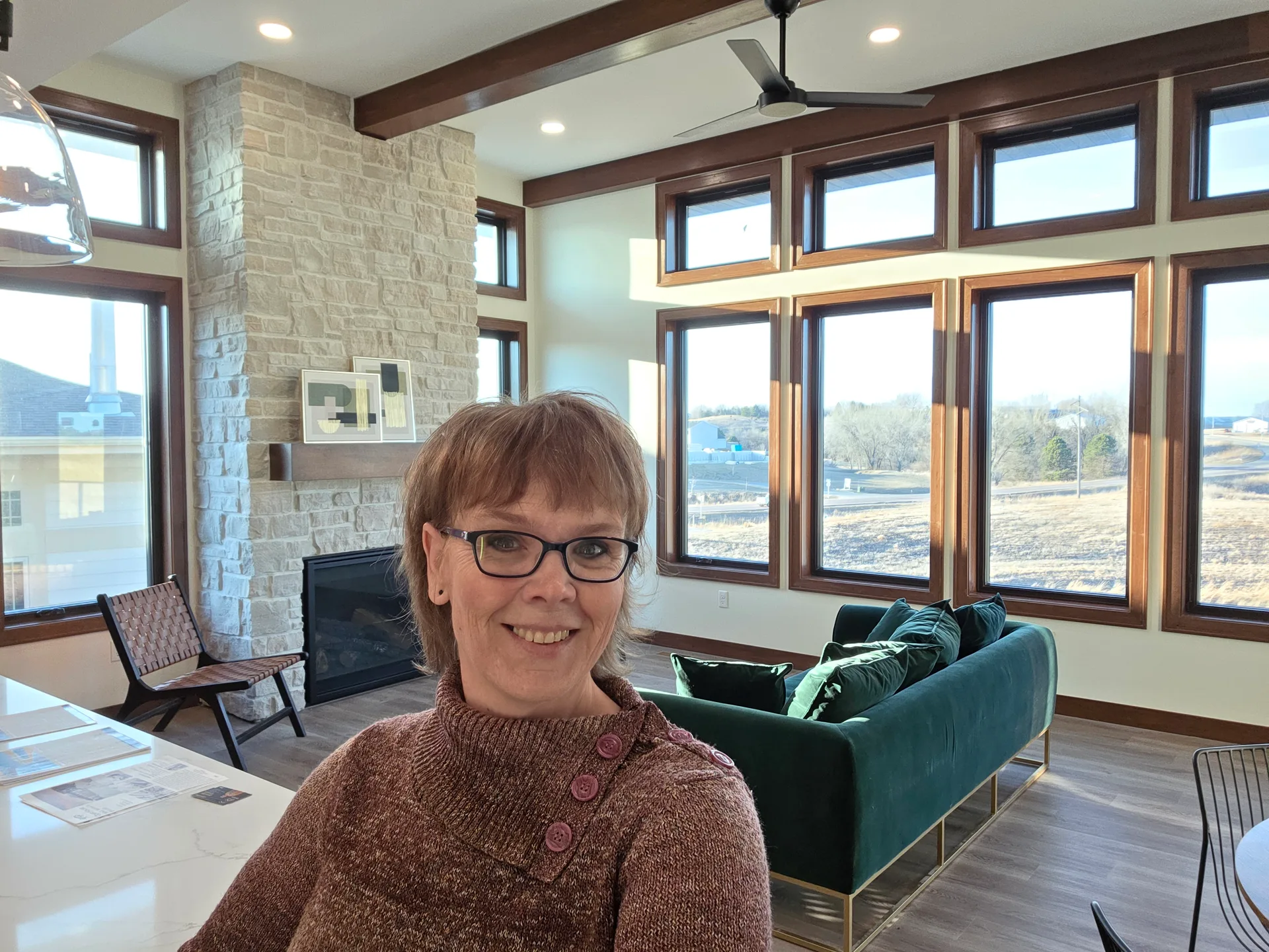 A bright, modern move-up home with a stone fireplace and large windows in the Sioux Falls area